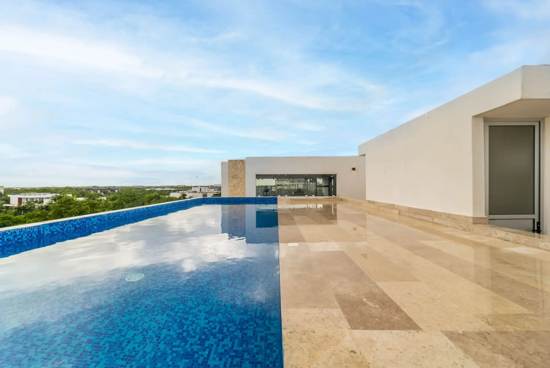 Relax by the rooftop pool with sunset vibes.