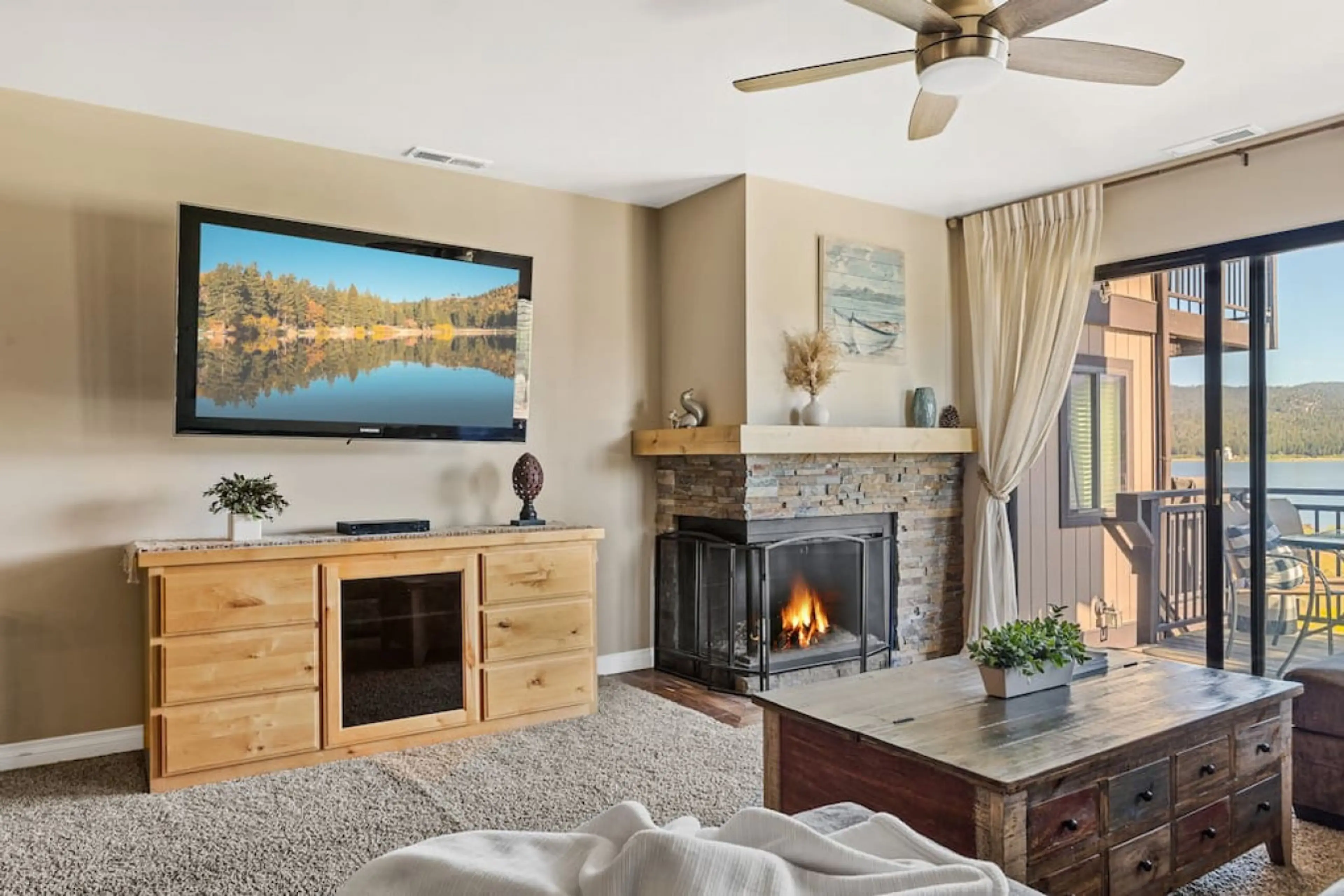 Welcome to Lakefront at the Village.   Relax in the living room space with a Smart TV,  gas fireplace, sofa and amazing views of the lake.