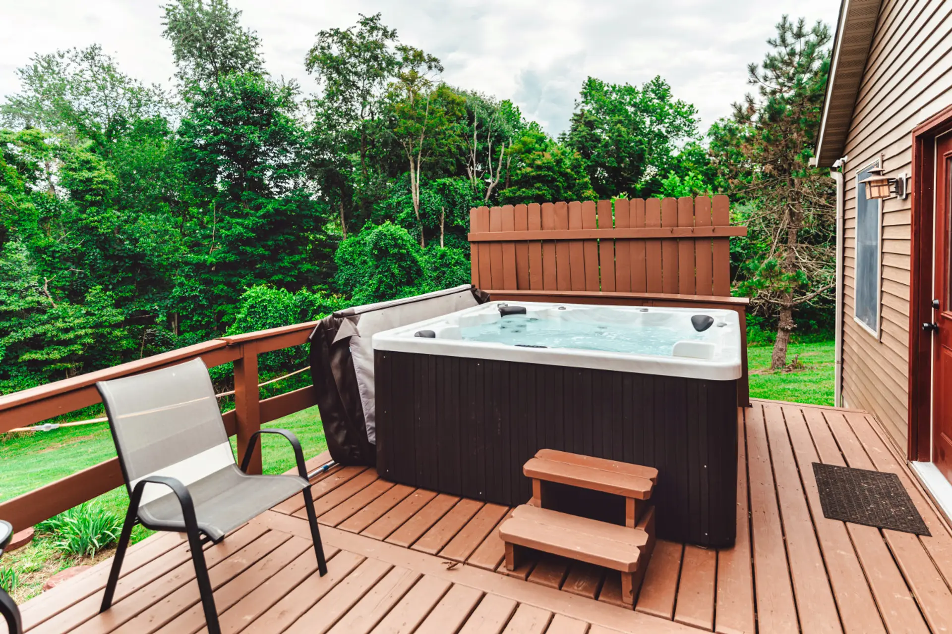 Forest-view hot tub on the deck creates a relaxing retreat after hiking and outdoor adventures