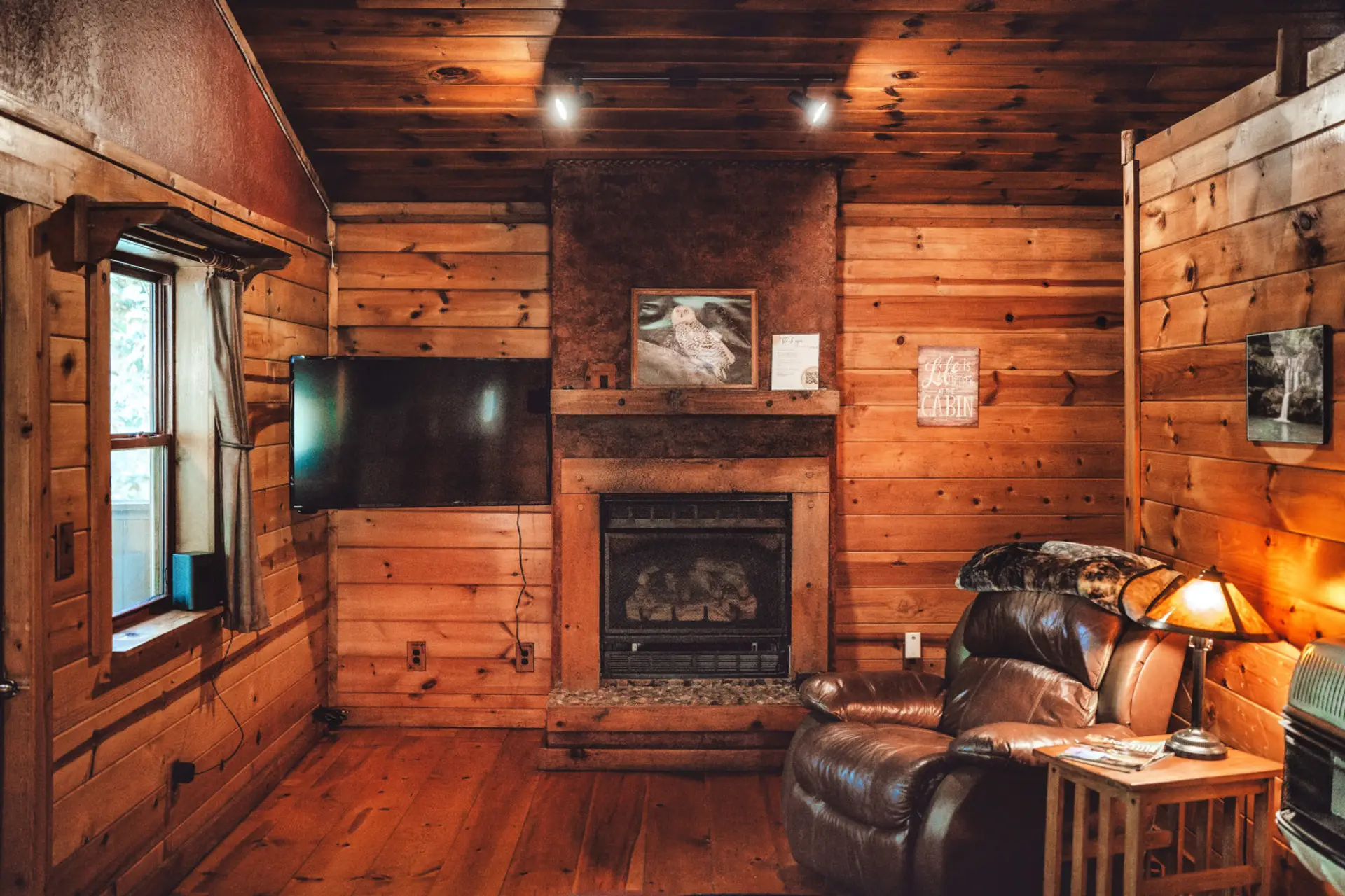 Cozy living room with fireplace and smart TV makes cabin nights feel warm, relaxed, and romantic