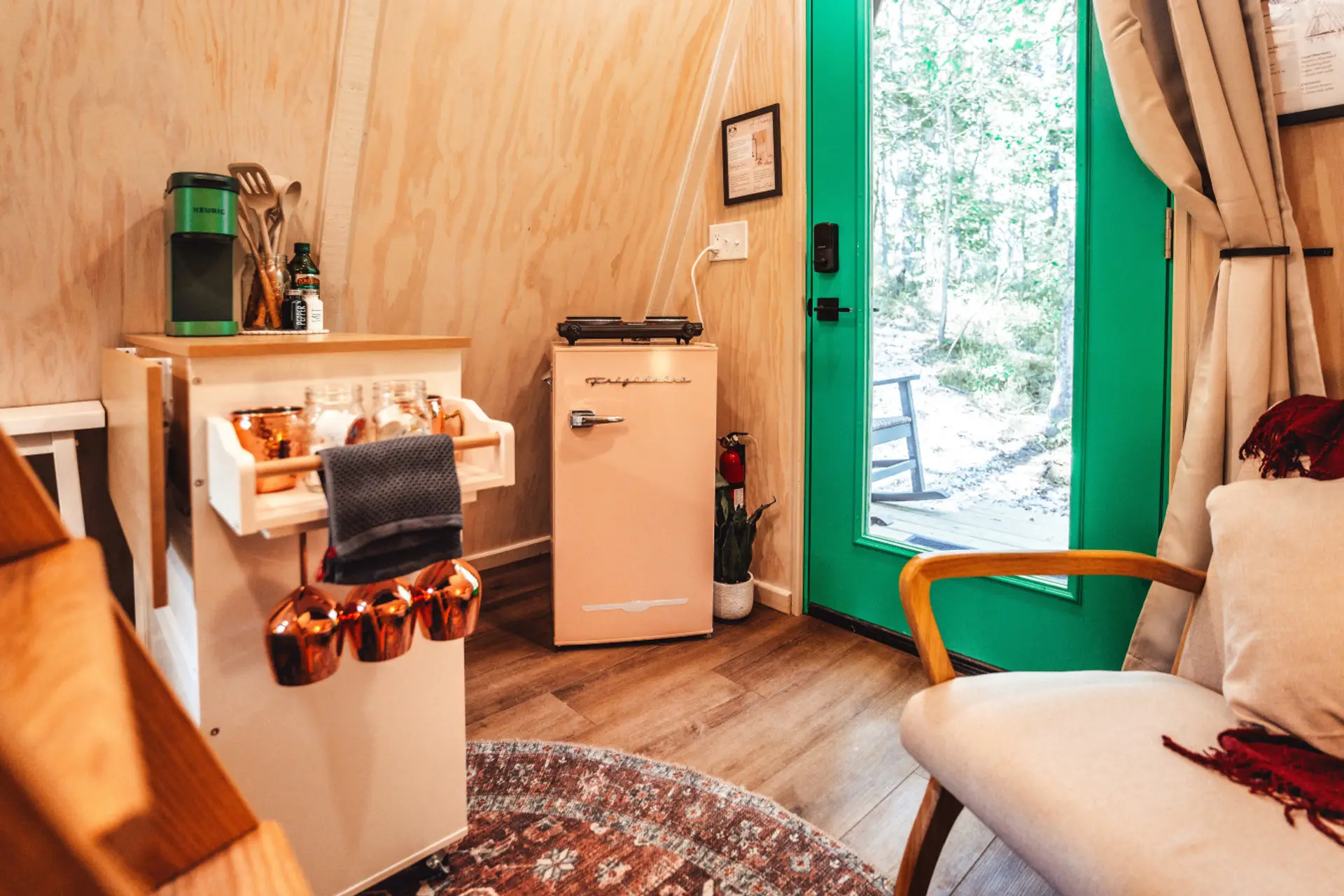 Sip fresh coffee beside the green doorway before easing into a cozy couples getaway in the woods