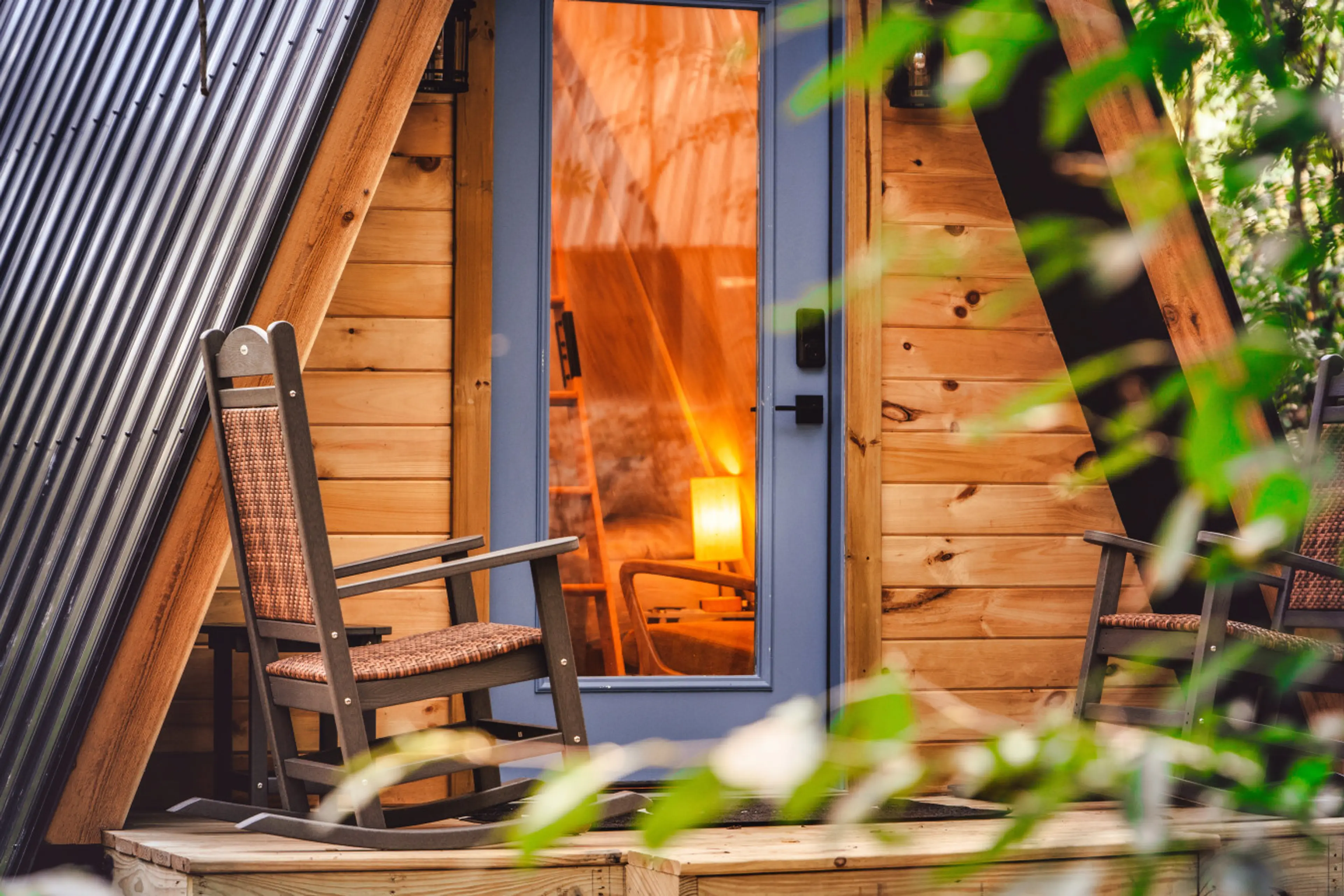 Share slow mornings on the private deck, rocking together beside warm wood walls and peaceful forest greenery.