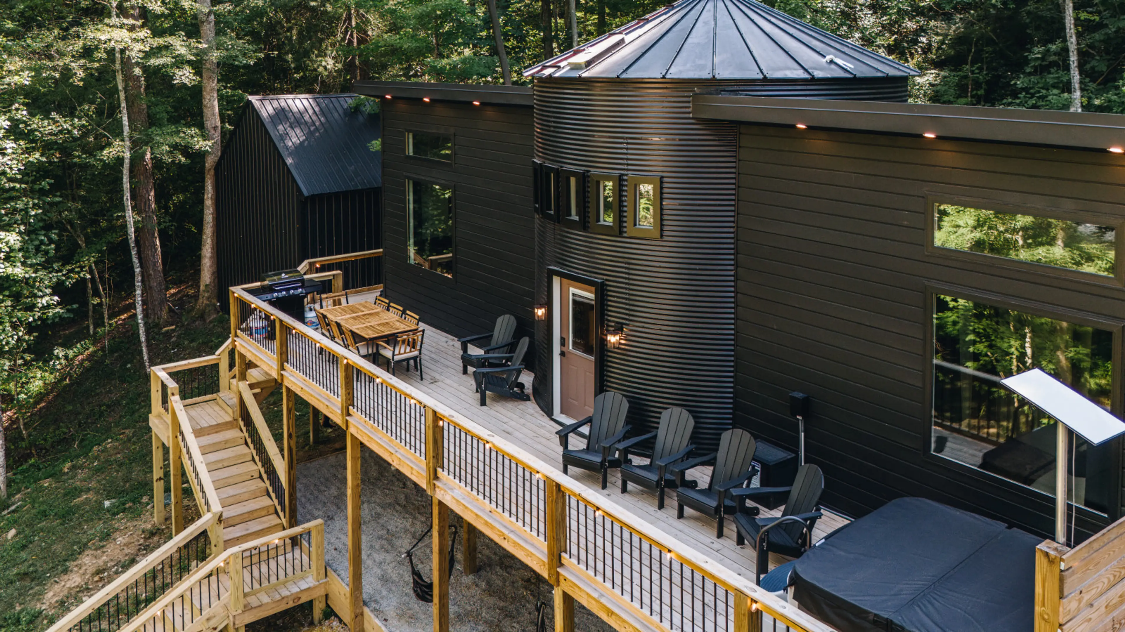 A spacious deck overlooking the woods creates the perfect balance of relaxation and adventure—complete with a hot tub, grill, and plenty of outdoor seating.
