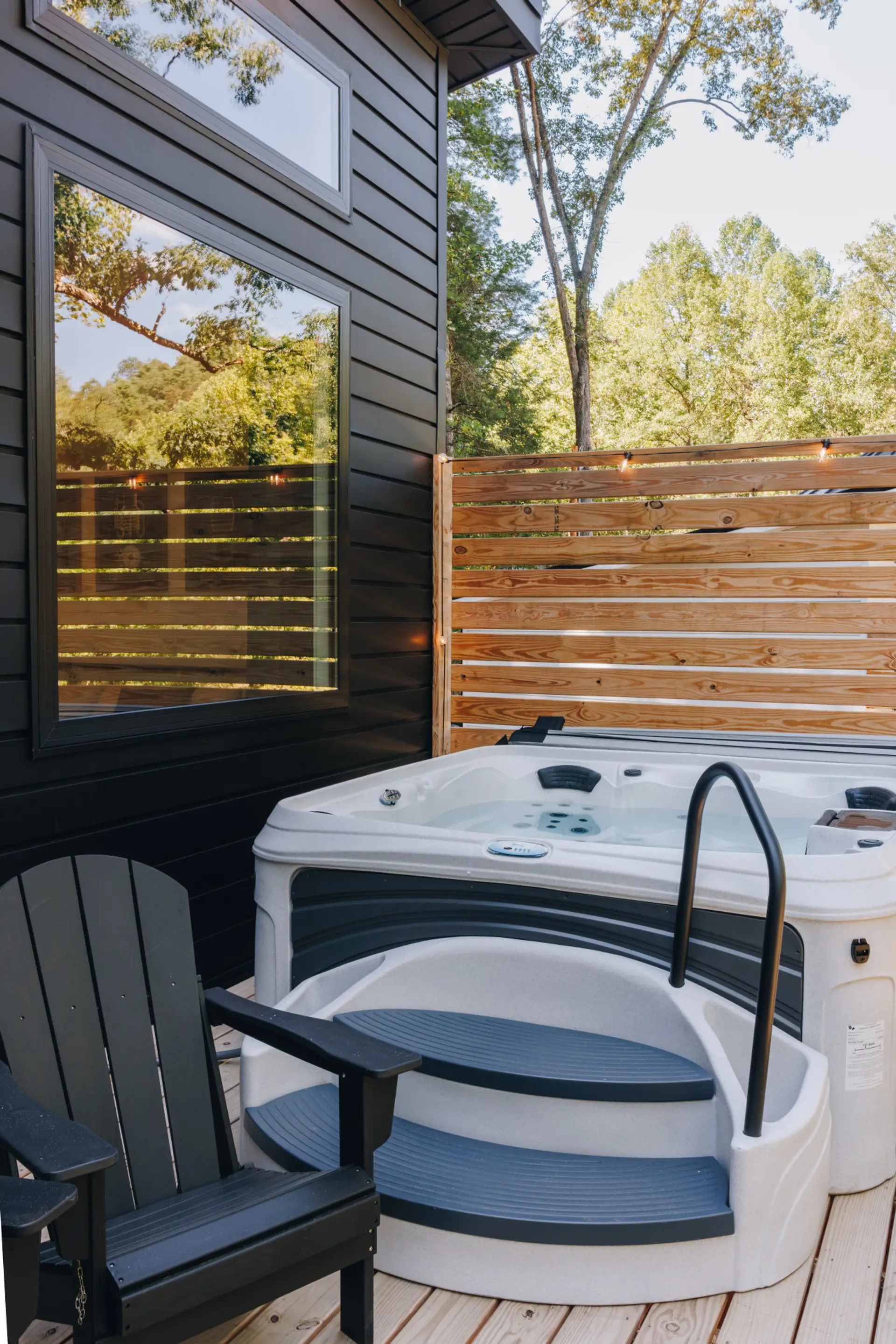 Steam rises off the private hot tub as string lights glow against the wood privacy wall. This is where cool fall evenings in the Gorge slow all the way down.