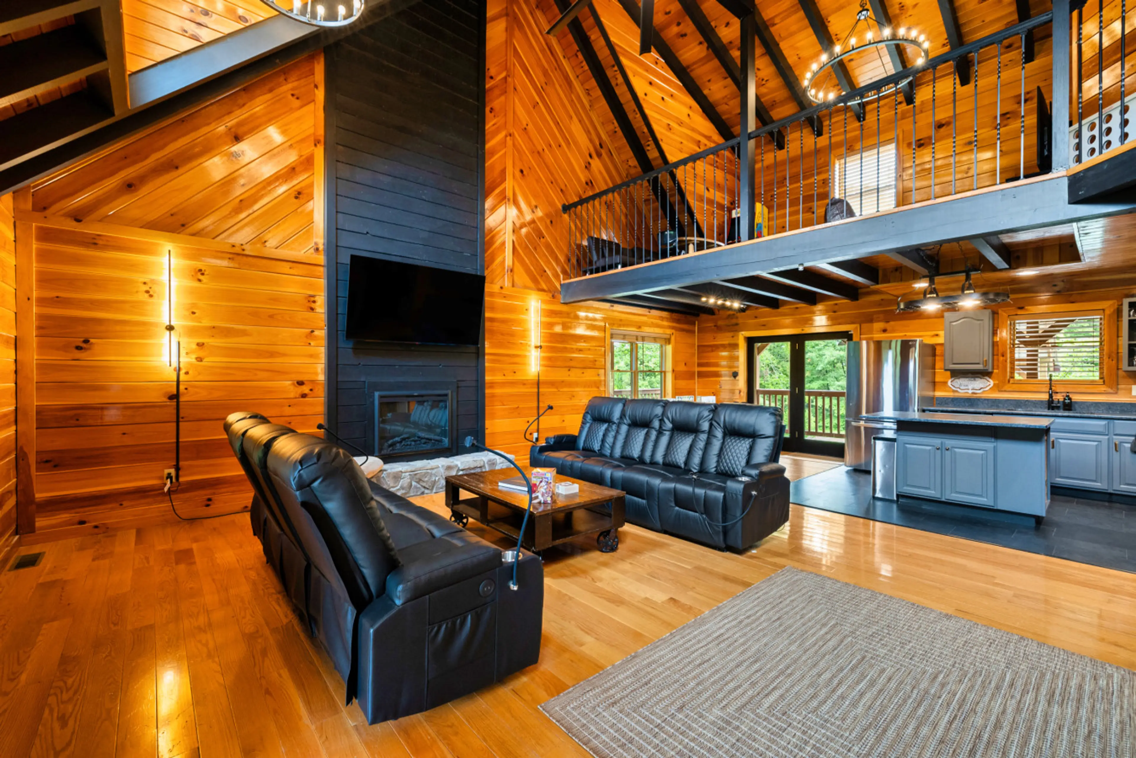 The open living room with vaulted ceilings and comfy leather couches for 8 guests
