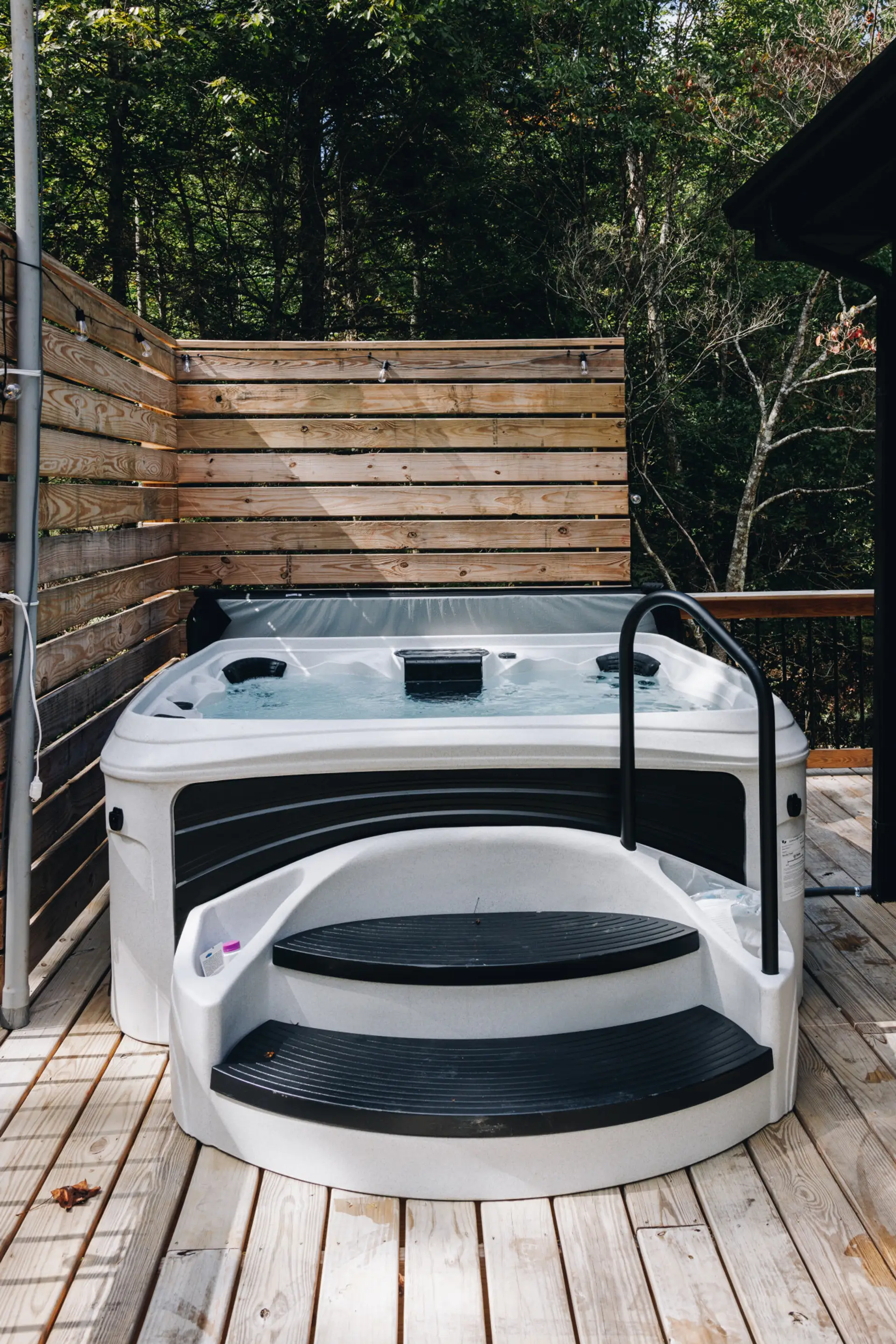 Tucked against a cedar privacy wall, the hot tub is the payoff after a day on the trails. Fall nights mean steam rising into cool air and stars overhead.