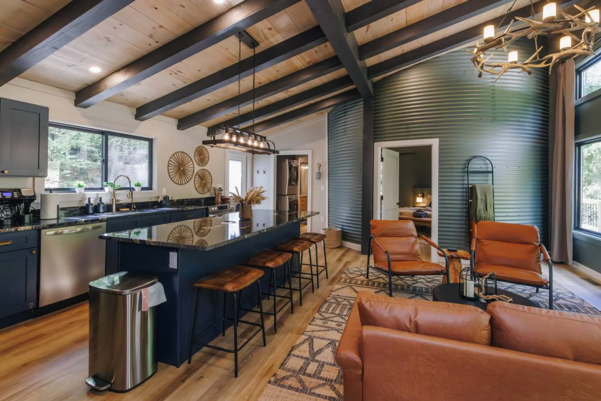 Vaulted wood beams meet the curved silo wall over a navy island and leather barstools. Coffee here, then out to the trails — or just stay and watch the leaves turn.