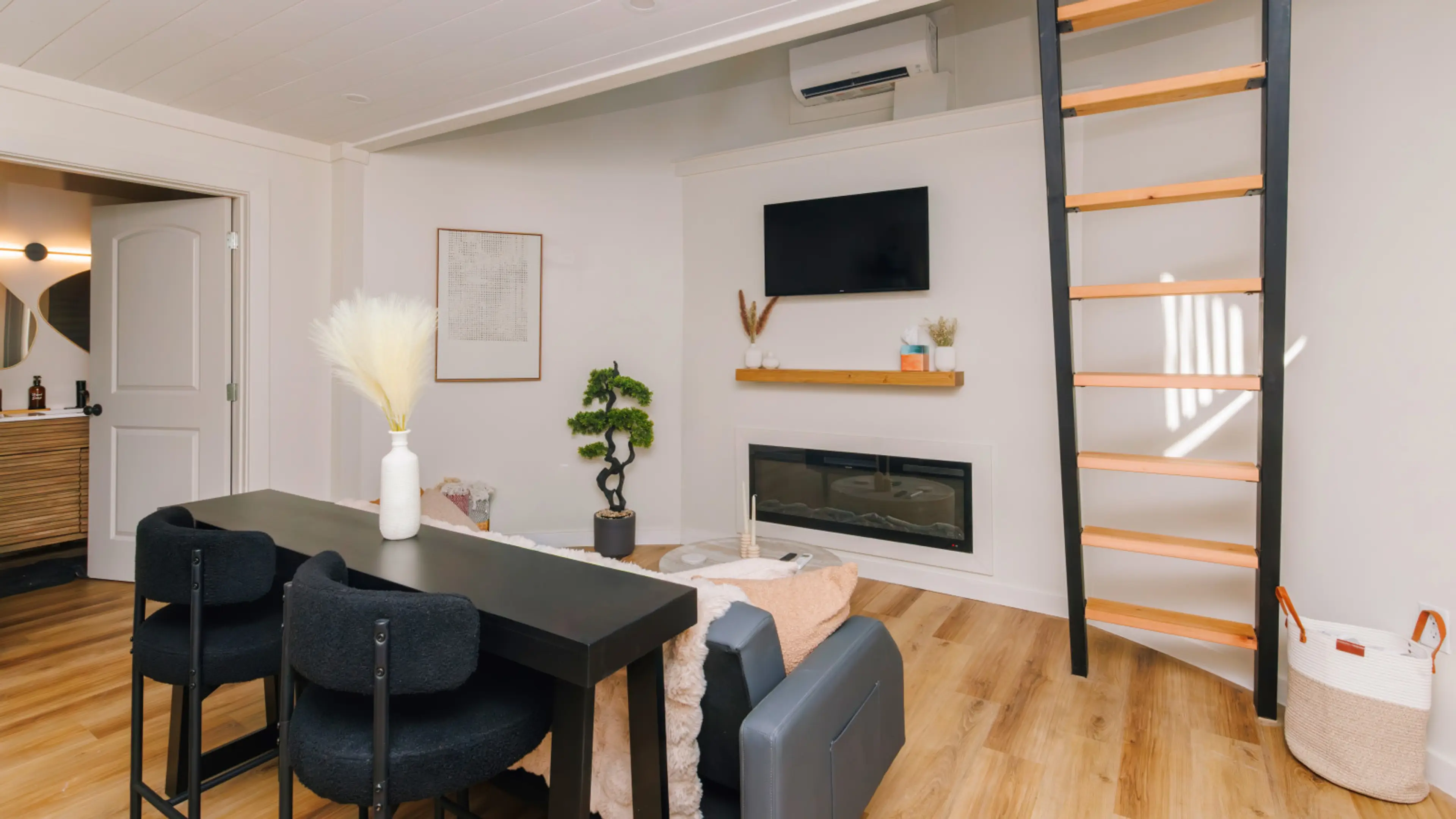 Compact, curated, and cozy. Warm up by the electric fireplace after a hike, or grab a snack at the bar before climbing the ladder to your loft bedroom.