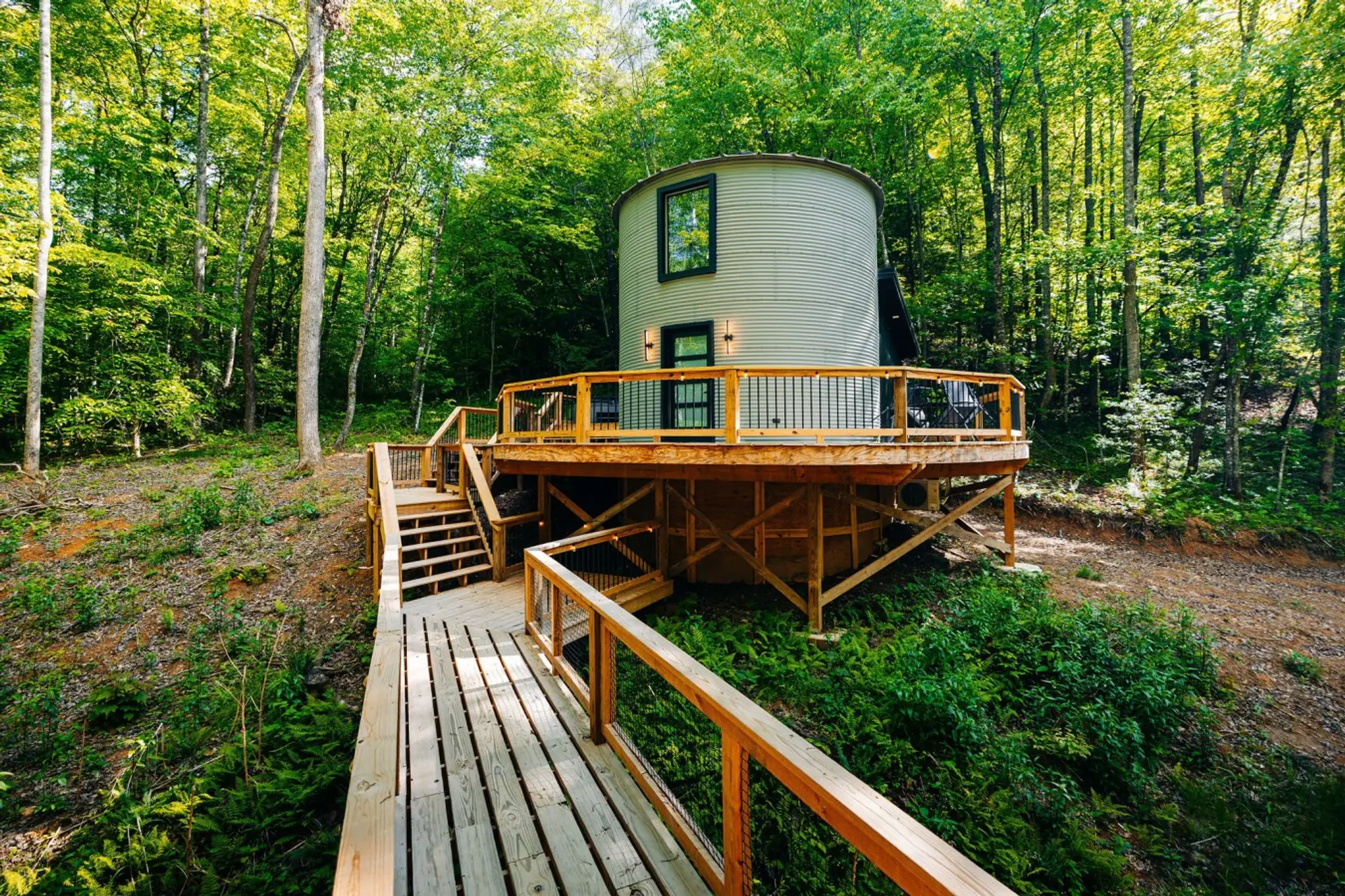 Welcome to The Yoder by The Hideaways. Step onto your private wrap-around deck and breathe in the crisp forest air. Whether it’s morning coffee or stargazing, this converted silo is your front-row seat to nature.