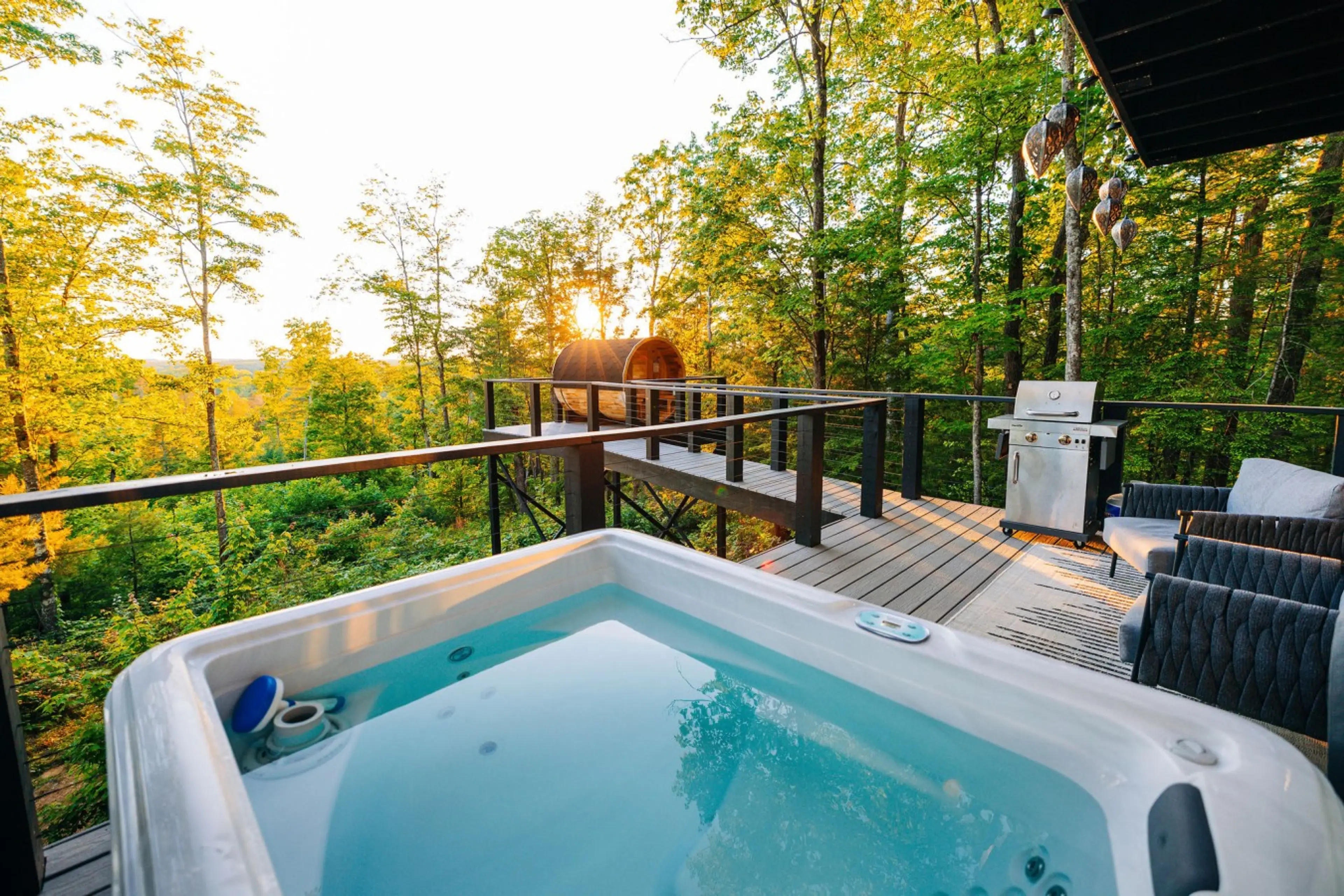 Private hot tub overlooking the peaceful forest views ideal for sunset soaking and quiet romantic evenings