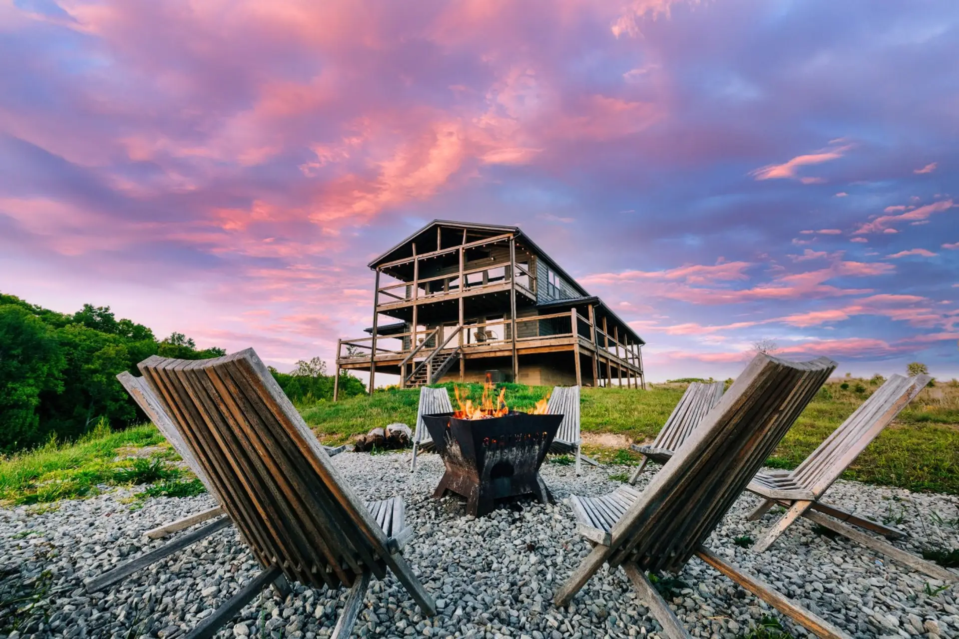 Gather around the fire pit at sunset, making vacation memories beside this spacious large group cabin