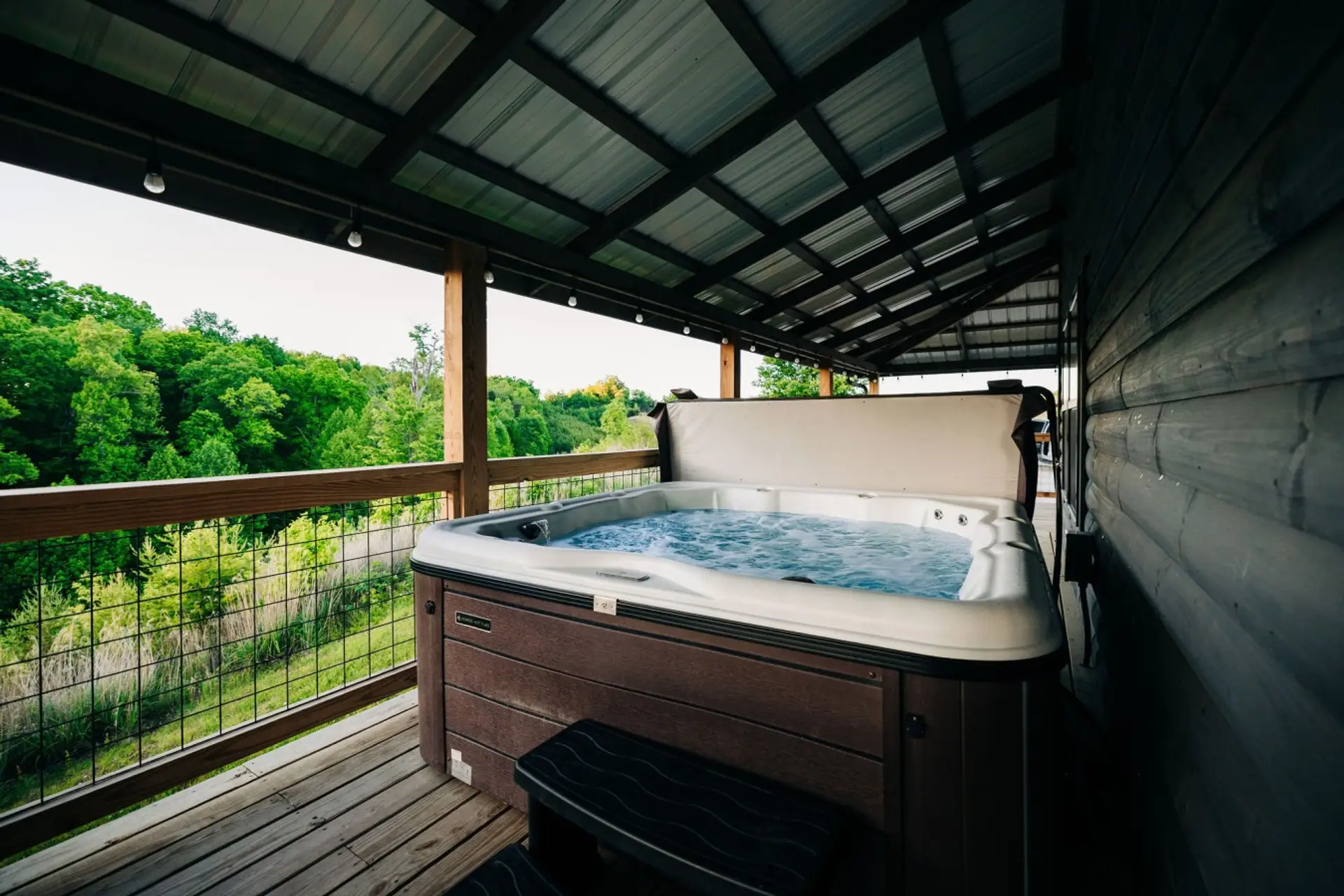 Covered hot tub with mountain views, perfect for relaxing after hikes during a friends getaway or family reunion