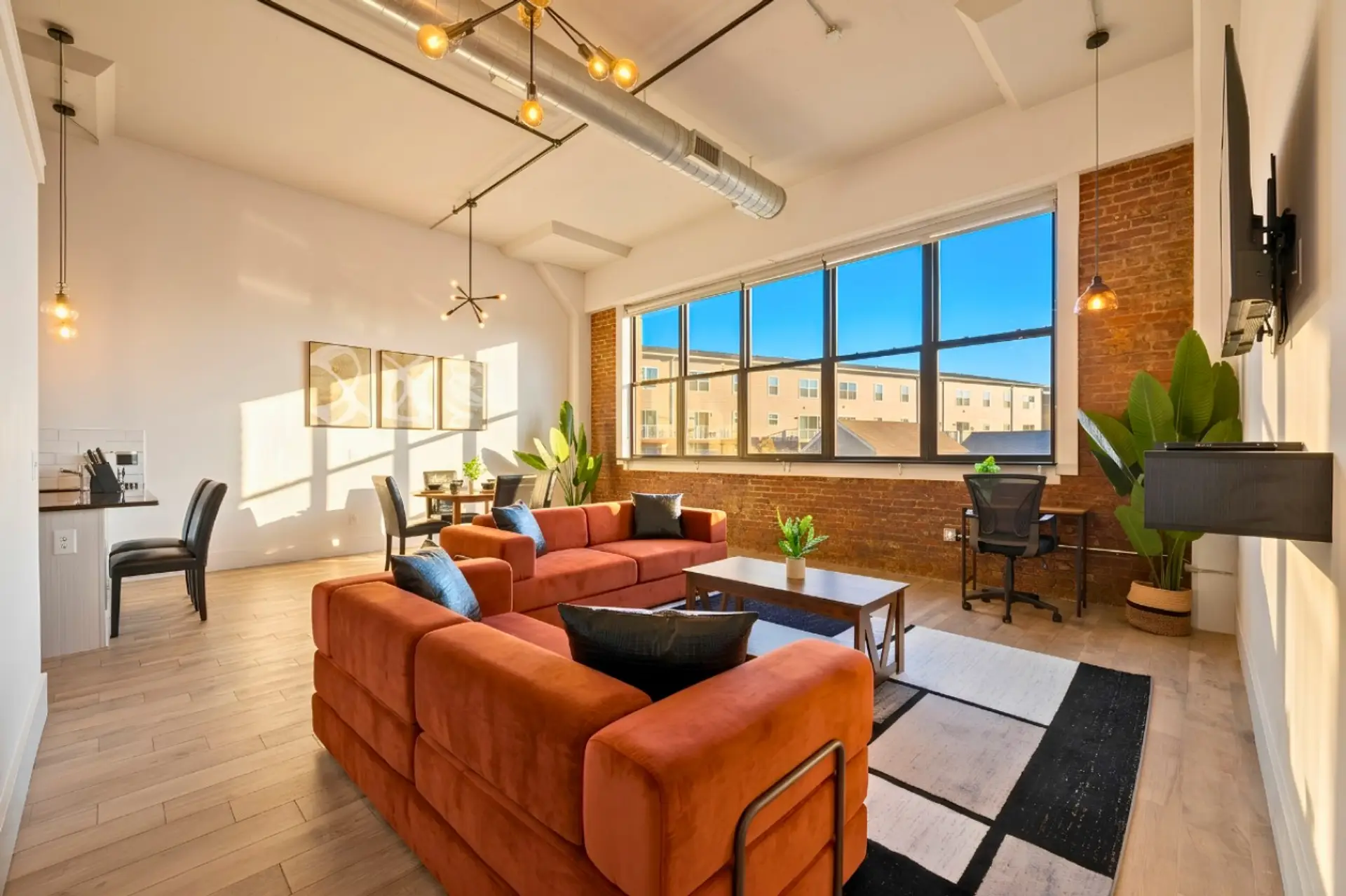 As you glance up, the high ceilings and exposed ductwork create an industrial loft vibe that’s effortlessly chic.