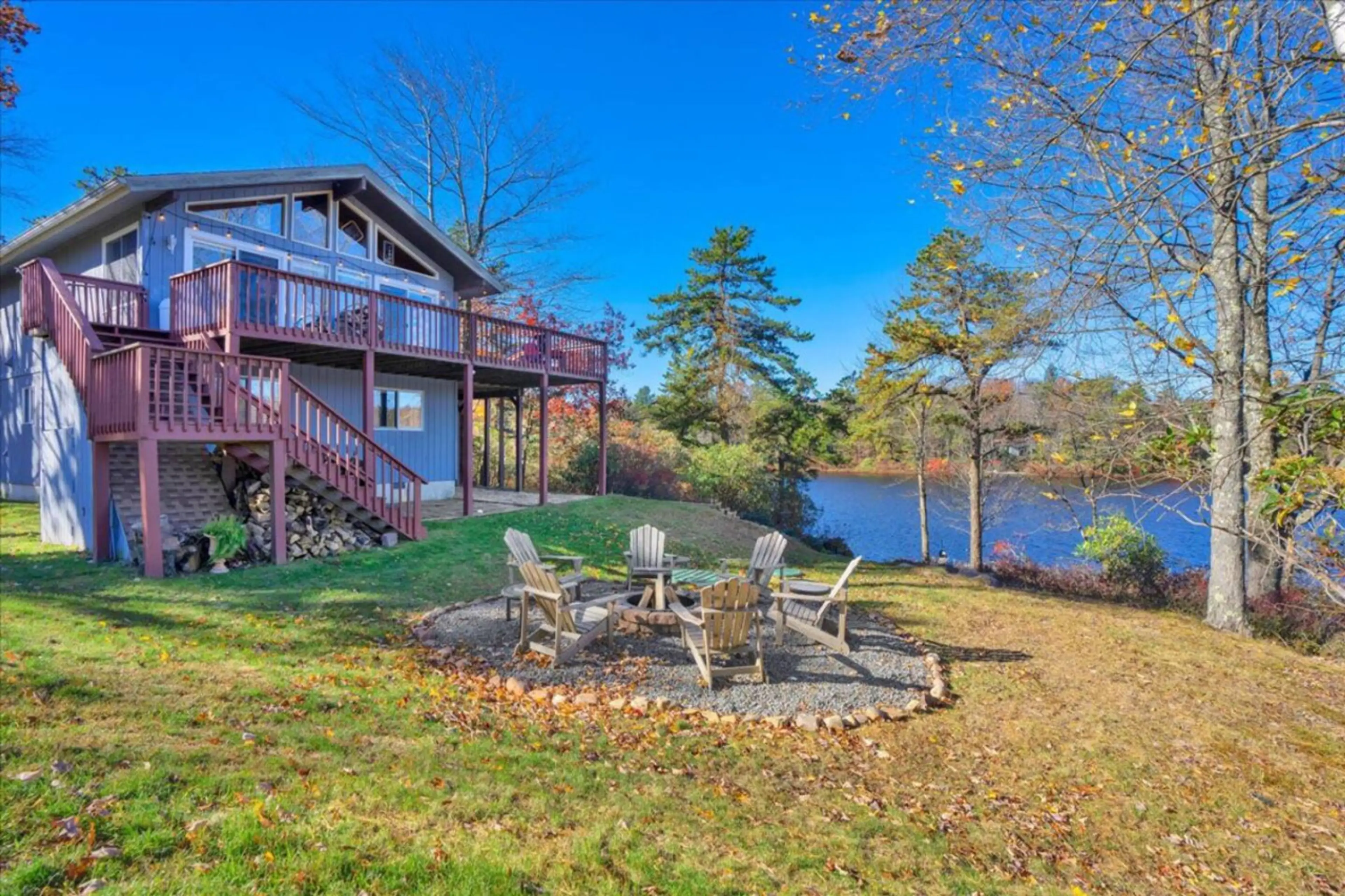 View of the expansive deck and lakeside firepit from the rear