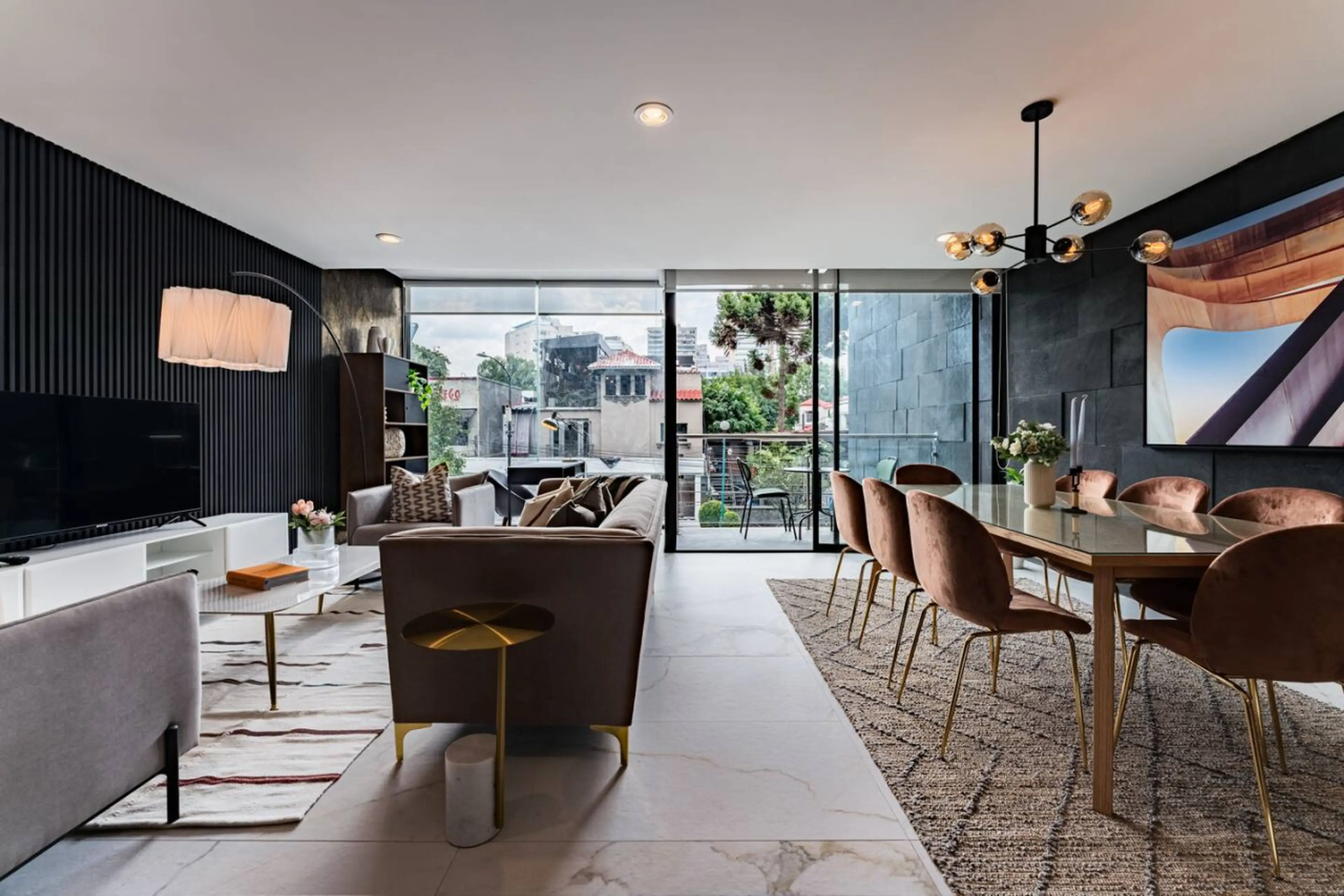 Elegant, sunlit dining and living space with floor-to-ceiling windows