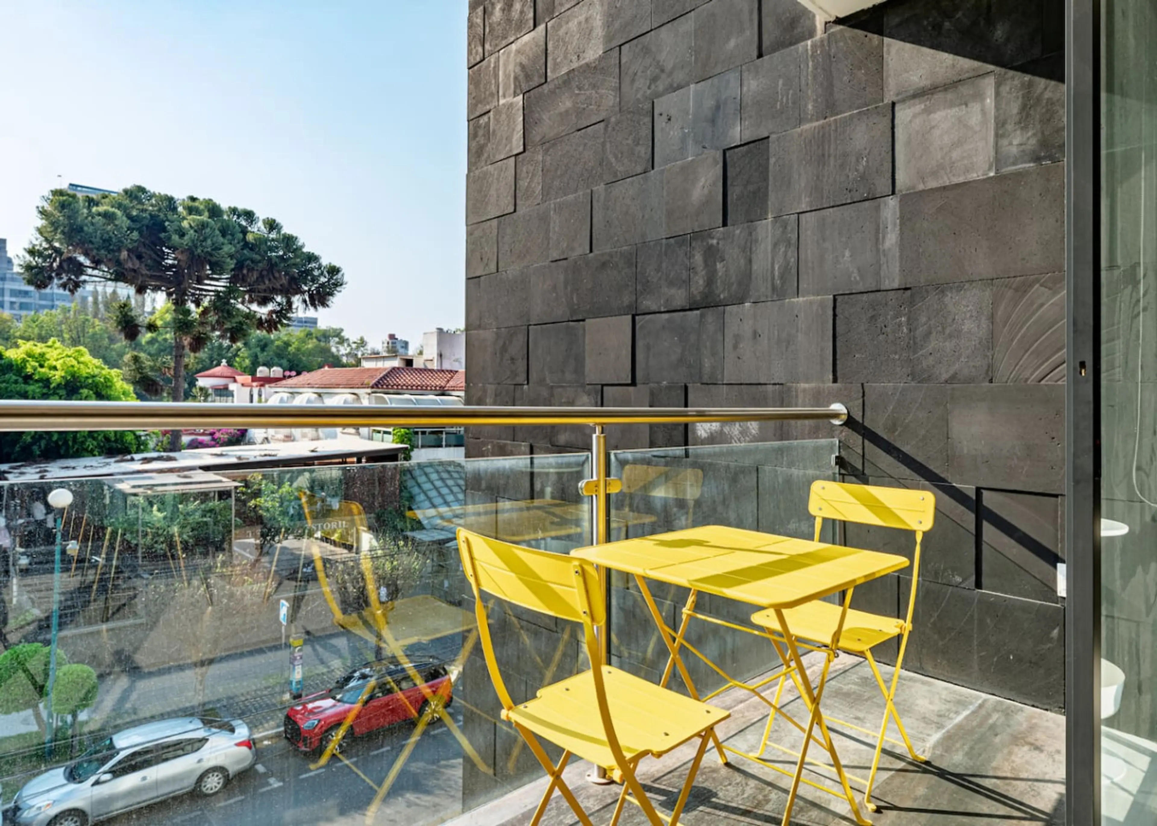 Private balcony with colorful seating, perfect for morning coffee or sunset drinks