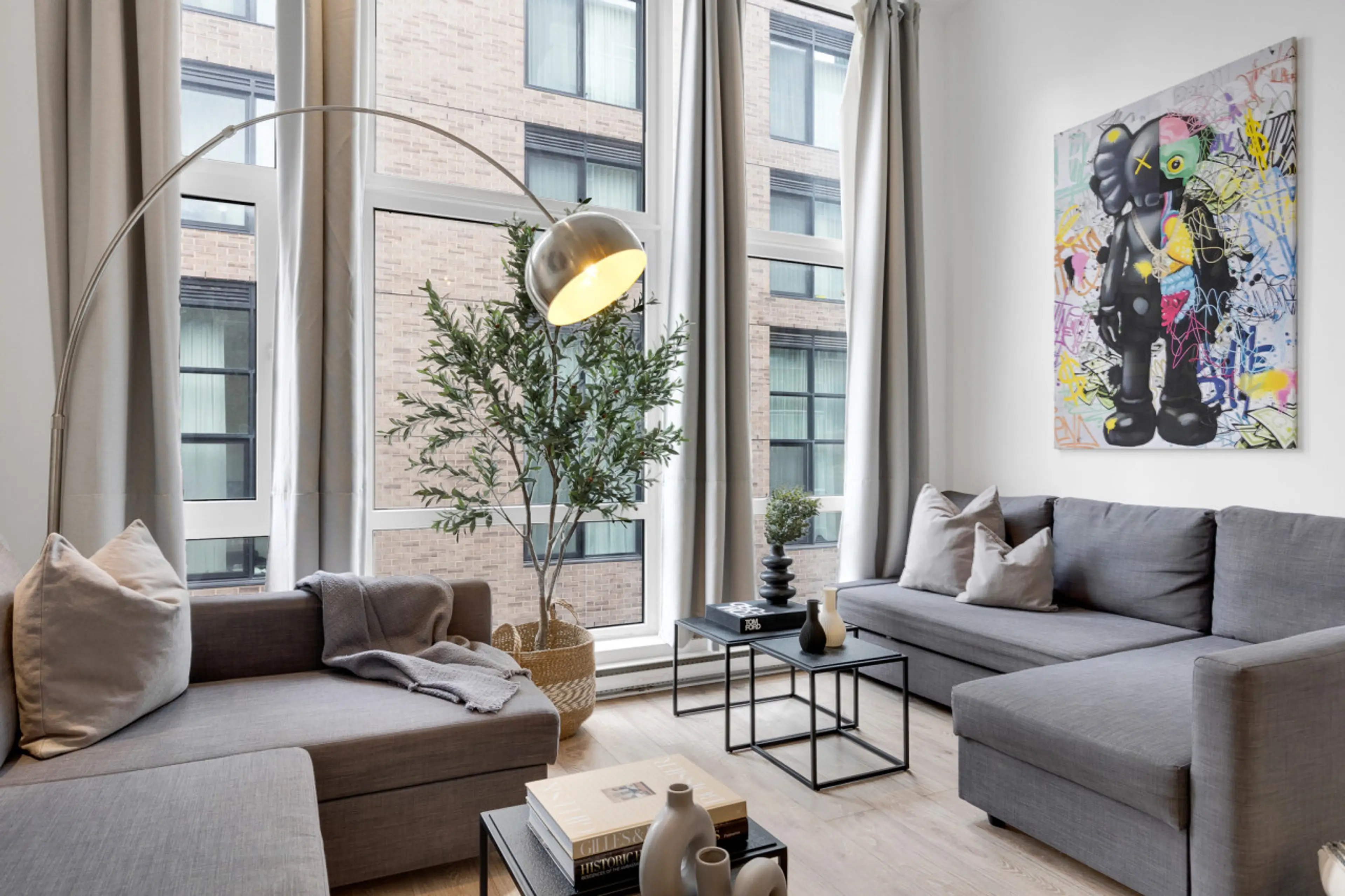 Living room: Features 2 queen sofa beds, 1 queen Murphy bed, and a Smart HD TV with access to Netflix, Disney+, and Prime.