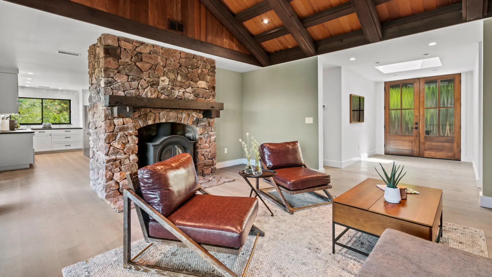 Relax in the rustic yet cozy living room with deck access and adjacent to the kitchen