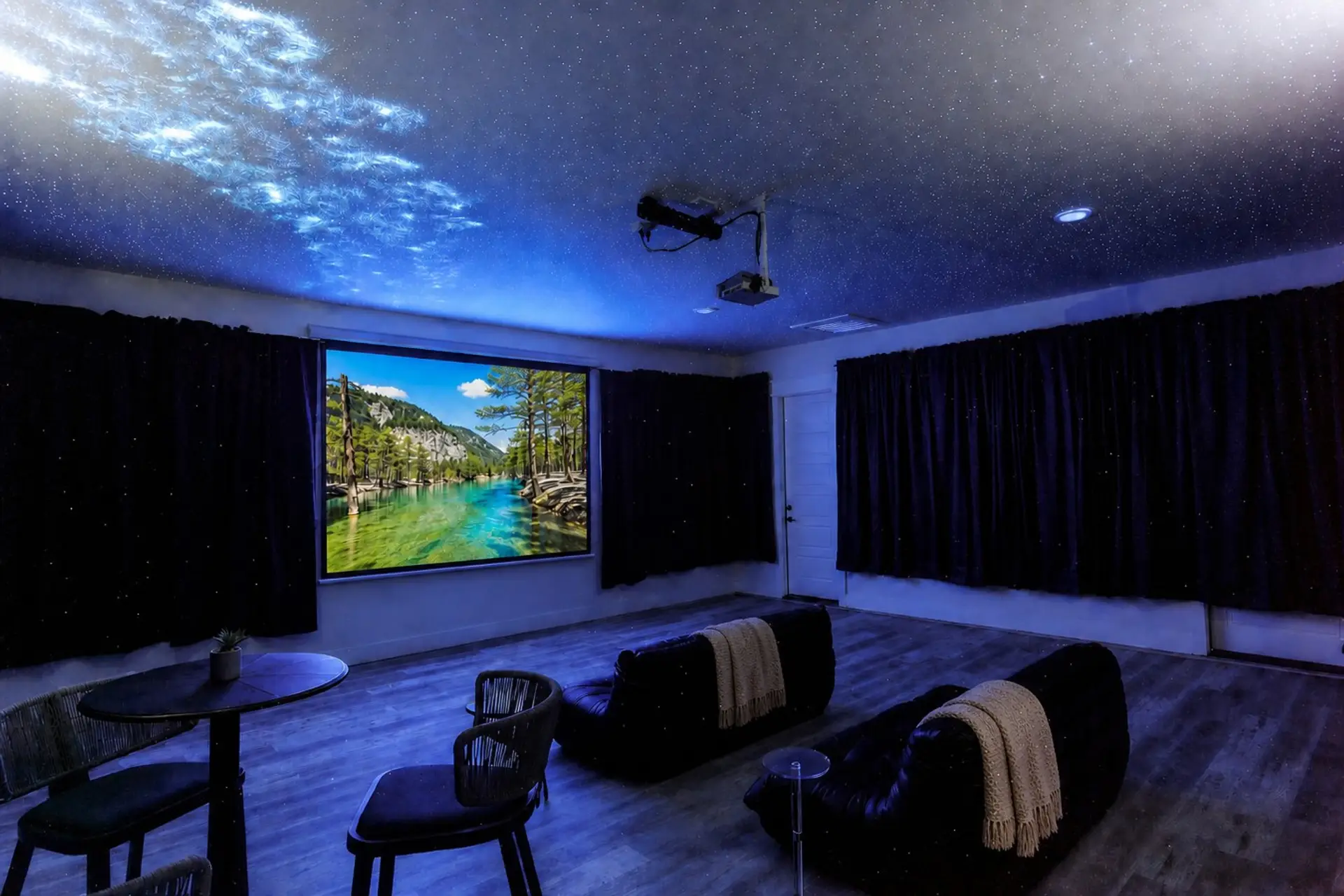 Full movie theater with 120" projector, starry ceiling, and cozy seating.