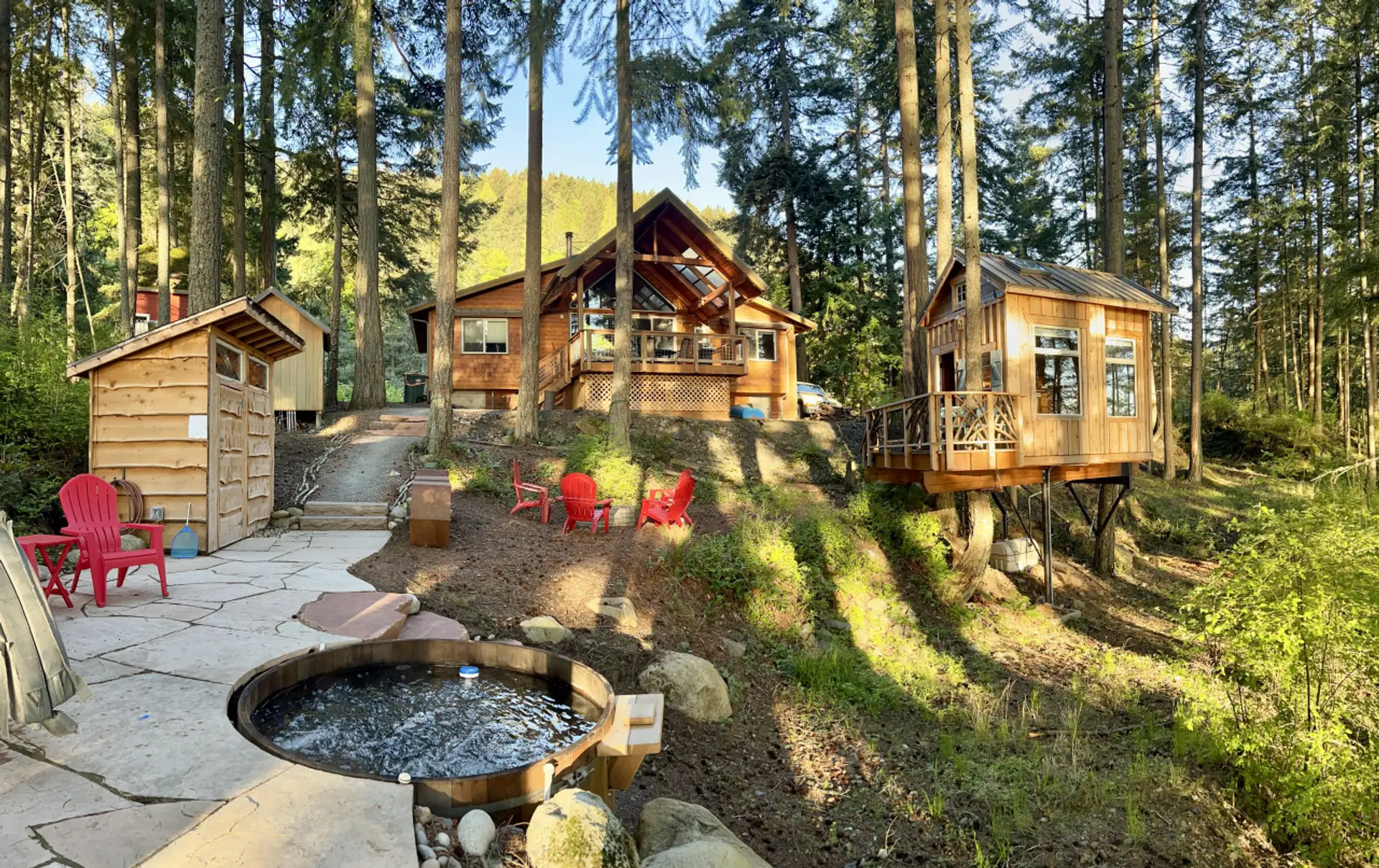 The setting of this cabin is superb, on a hillside with views on both sides. Paths wind through the backyard, to the firepit, hammock, shower house and the cedar hot tub!