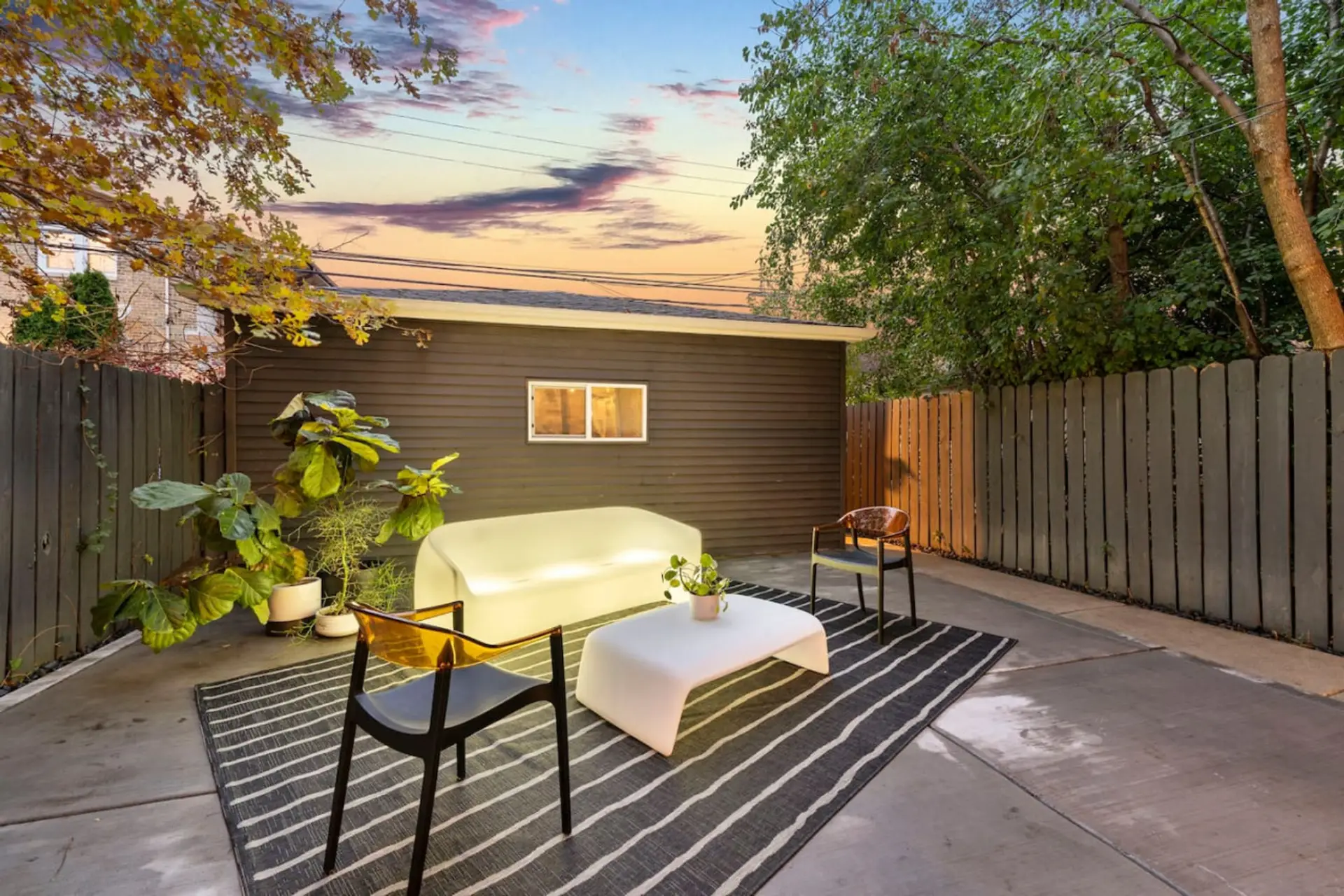 Escape to your private outdoor oasis, available May-October. Lounge on the illuminating sofa, sway in the hammock, gather around the table for 8, fire up the grill – all within the serenity of a fenced-in retreat