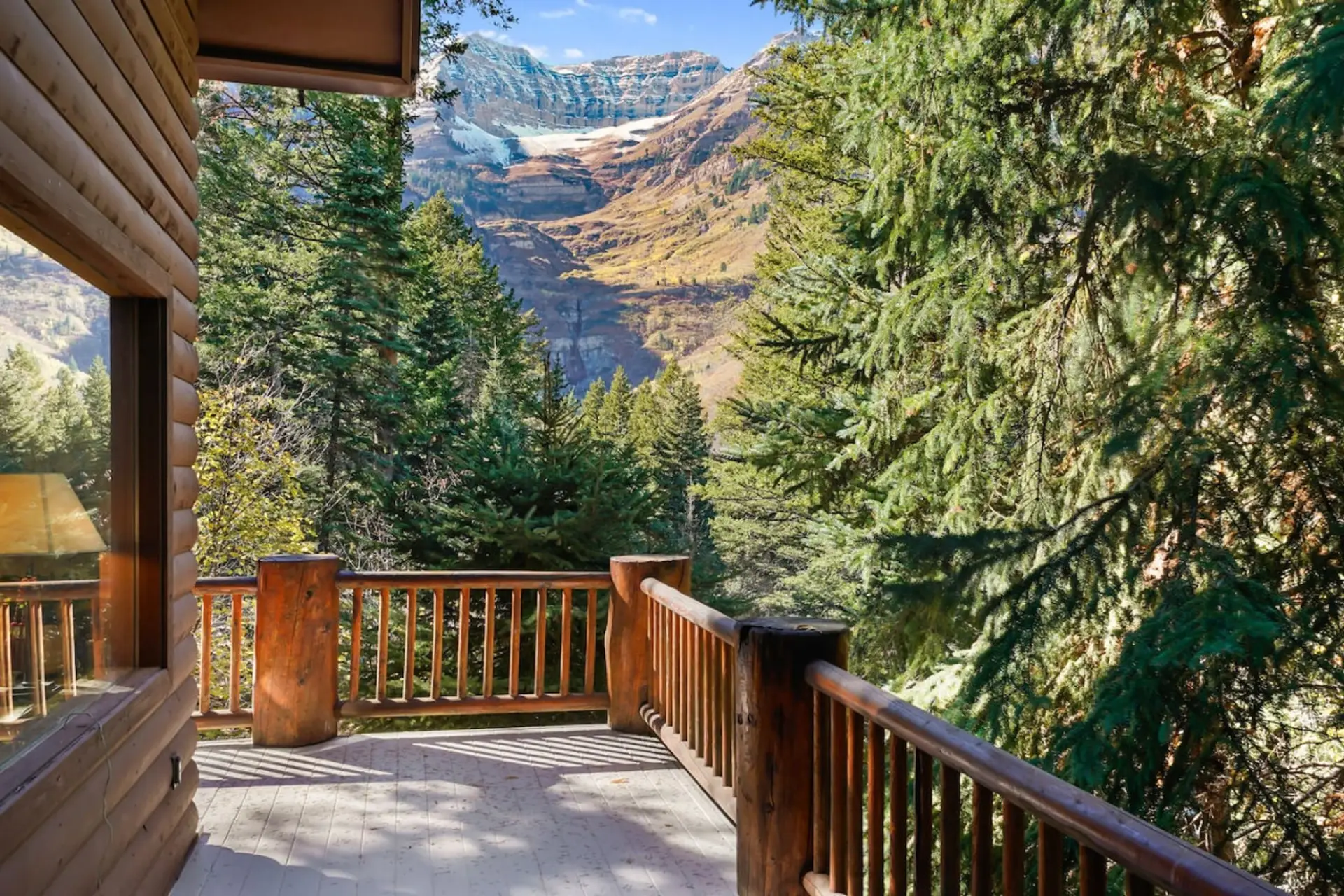 A large patio surrounded by stunning mountain and forest landscapes, perfect for relaxation.