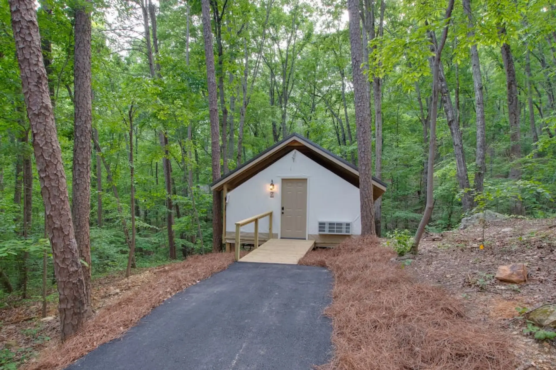 Spacious glamping tent featuring a private hot tub, king bed, and scenic views. Experience luxury camping in the heart of North Alabama Fishing Themed