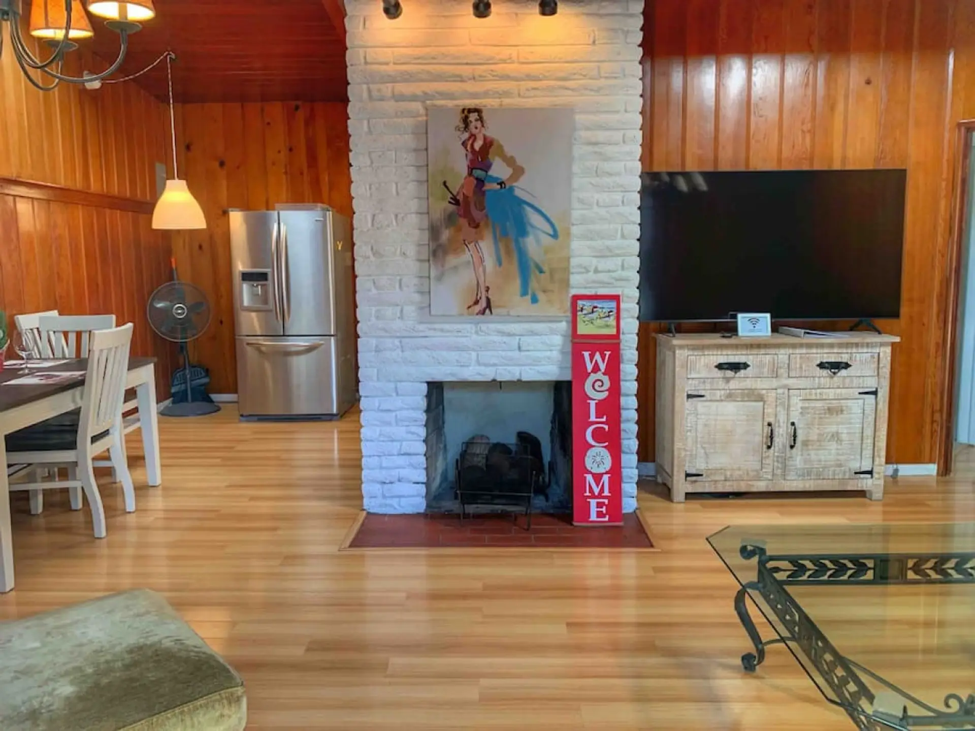 Cozy living space with a white brick fireplace and rustic-modern decor.