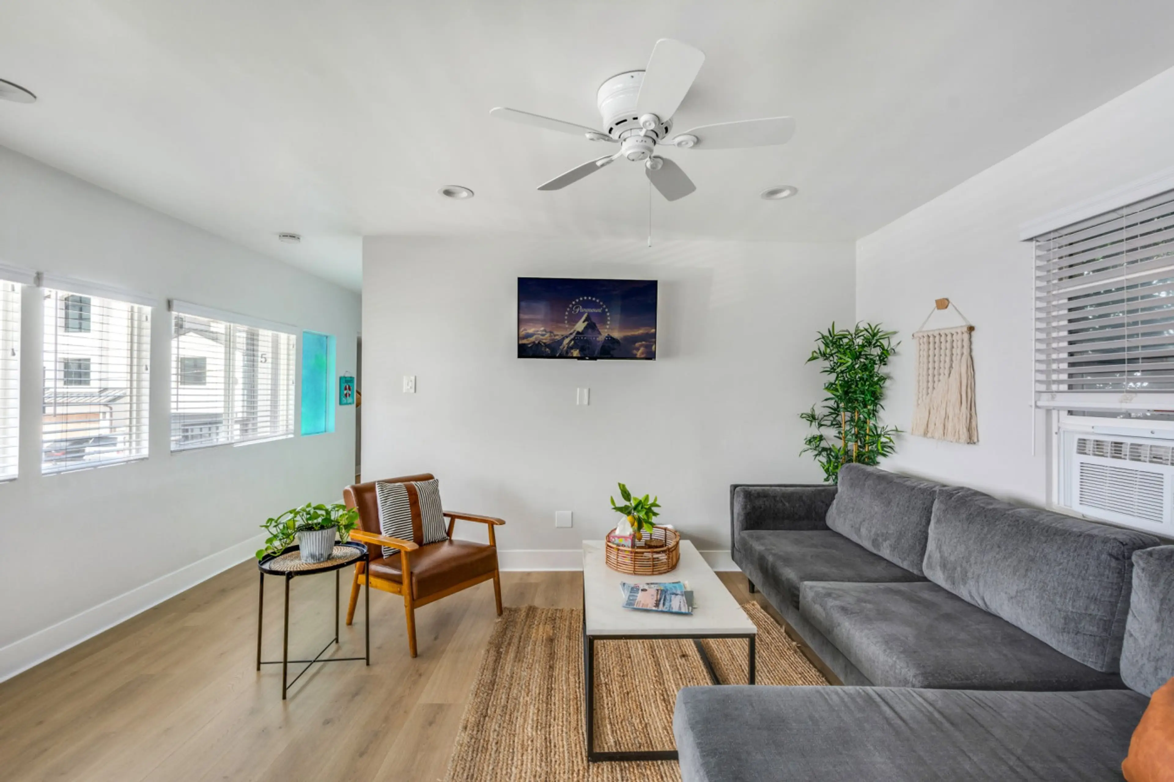 Large living room with lots of seating and windows to enjoy the ocean breeze.