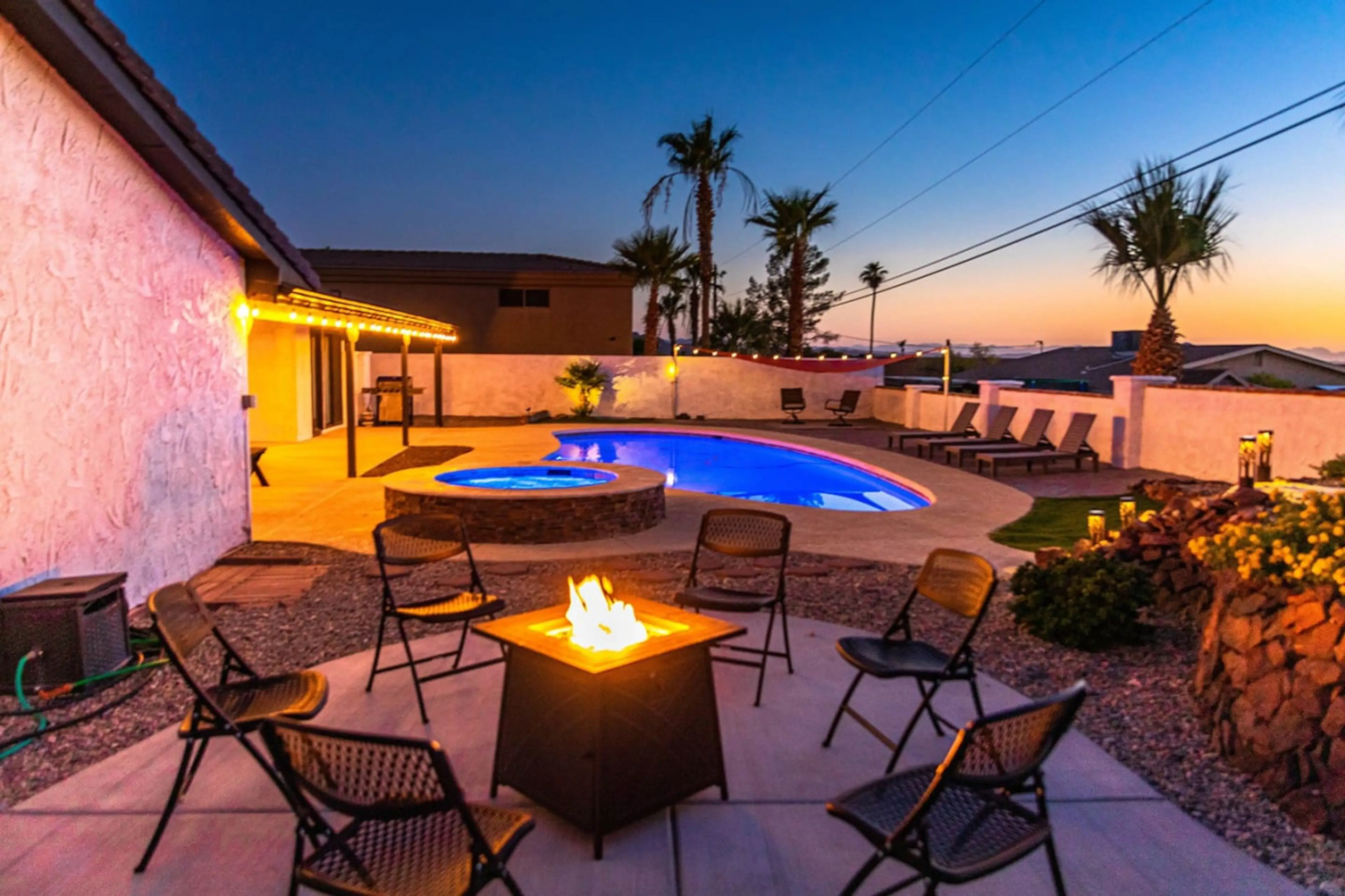 an expansive yard with a sparkling heated pool, SPA, BBQ grill, fire pit.