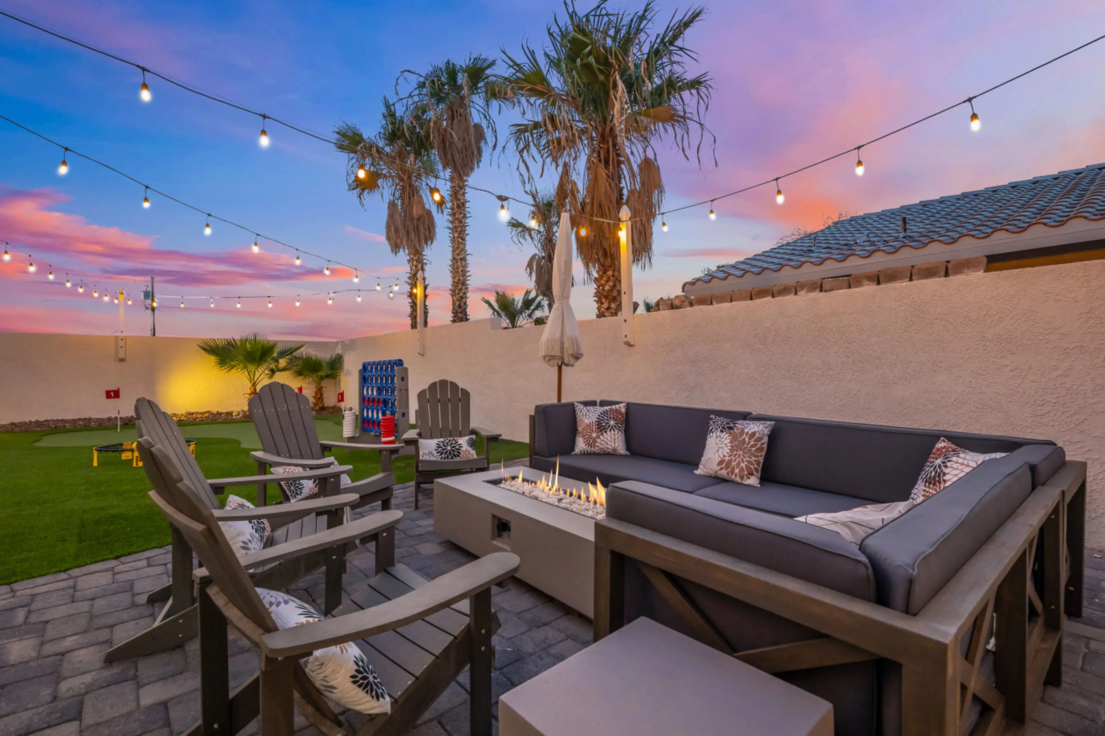 Relax in this outdoor seating area with a cozy furniture and a fire pit