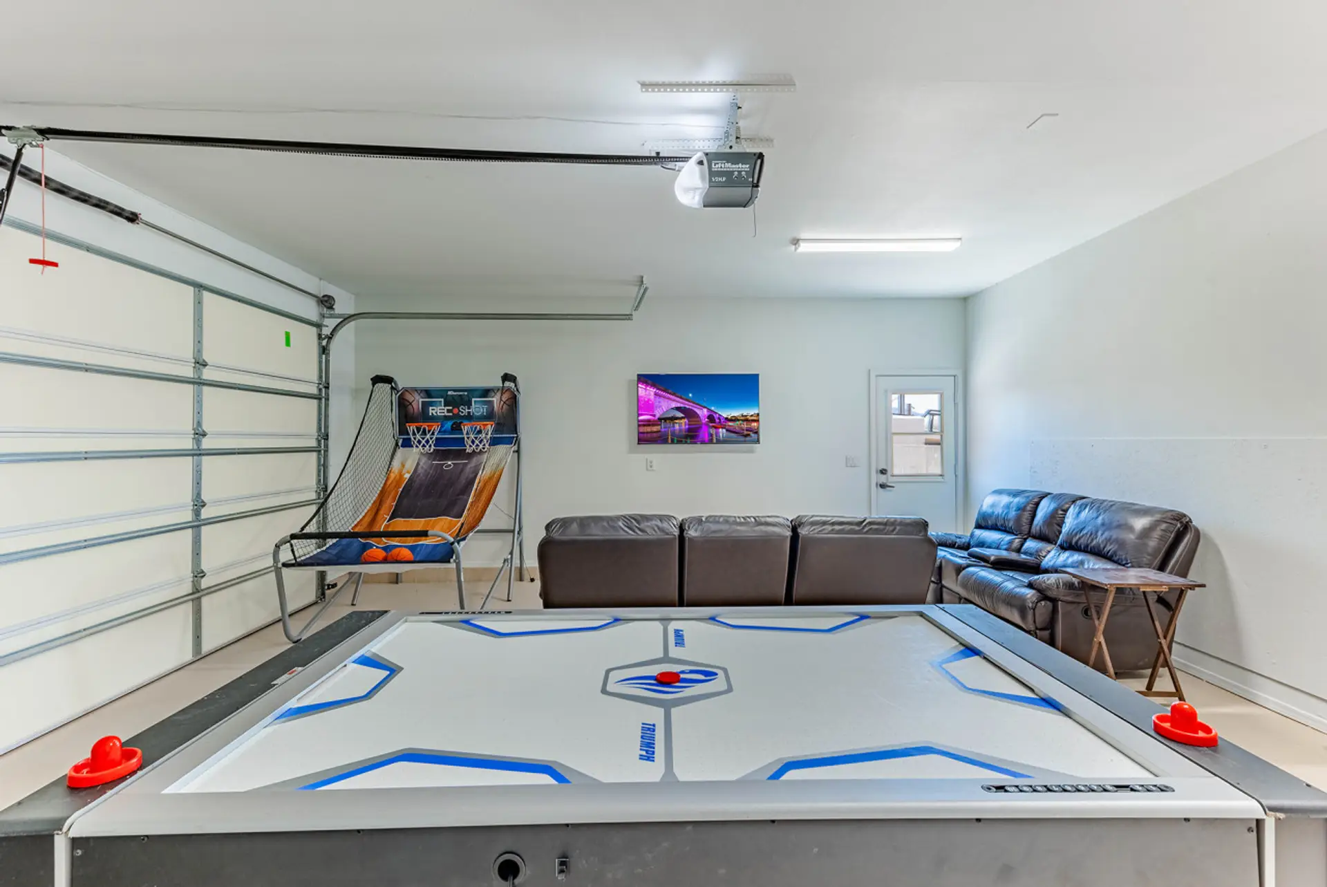 Fun-filled game room with air hockey and cozy seating.