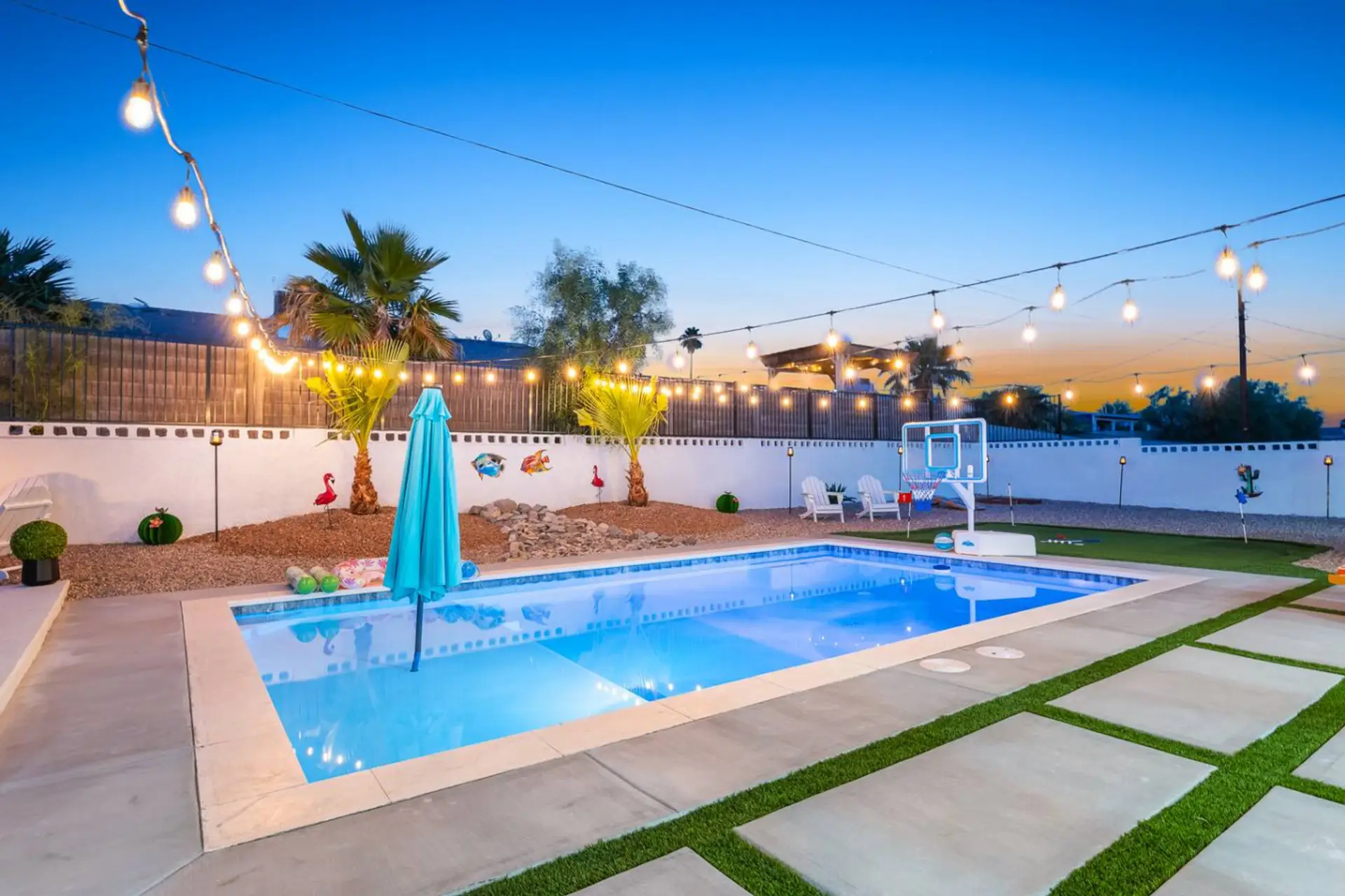 Dive into relaxation! Enjoy a private pool with basketball hoop, string lights, and serene desert sunsets.