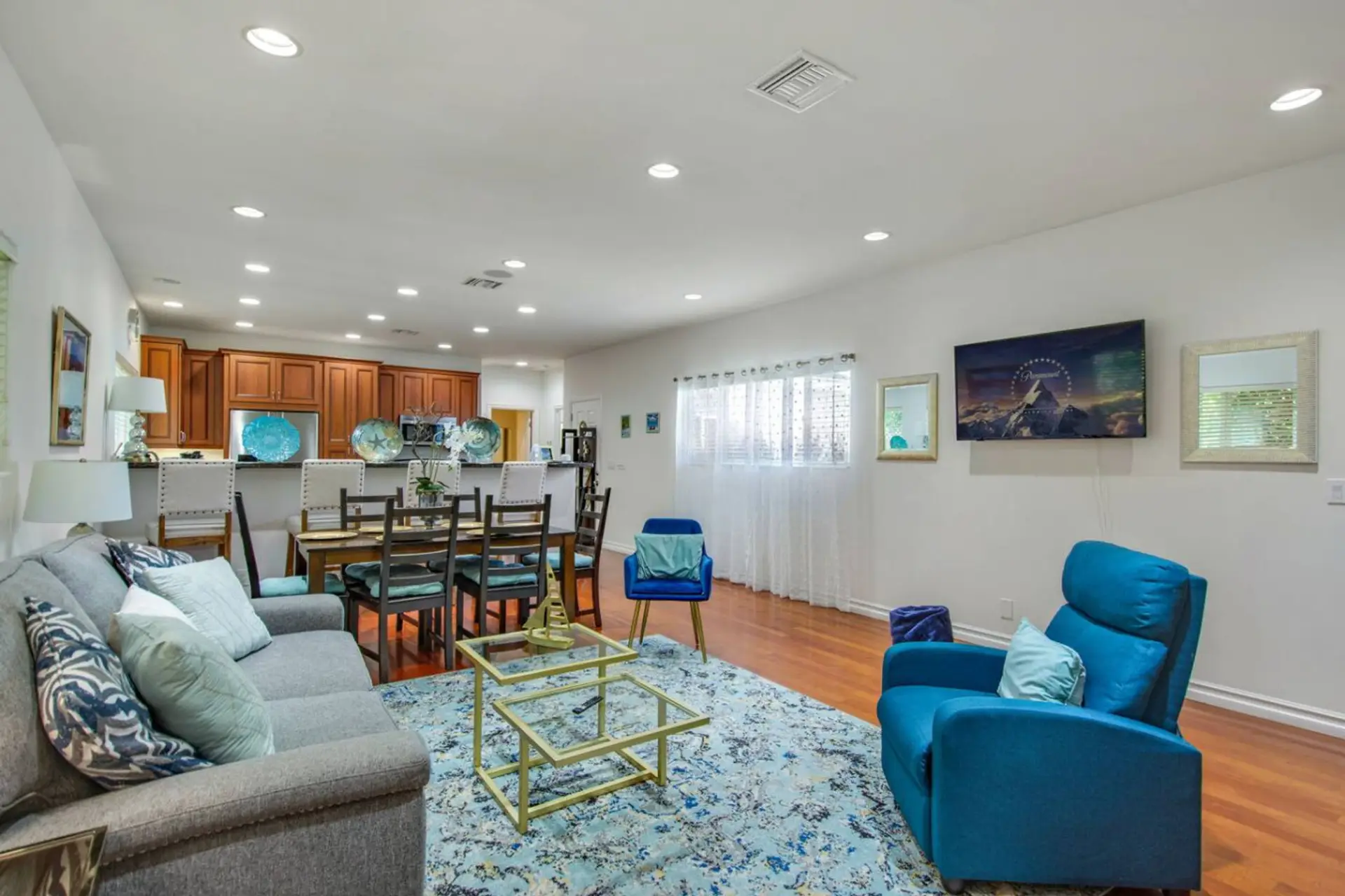 Spacious ADU living room with plenty of seating, a sofa sleeper, dining area for six, and Smart TV for entertainment.
