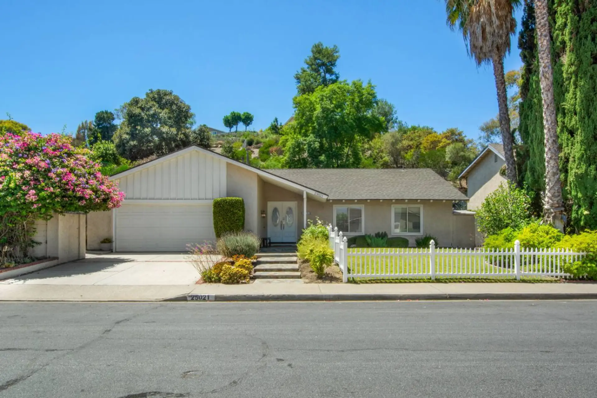 Enjoy convenient parking with a 2-car garage, spacious driveway, and additional parking in front of the home.