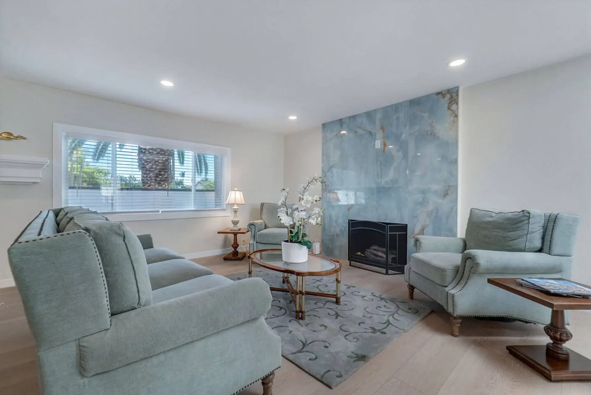 Bright living area with stylish fireplace and seating.