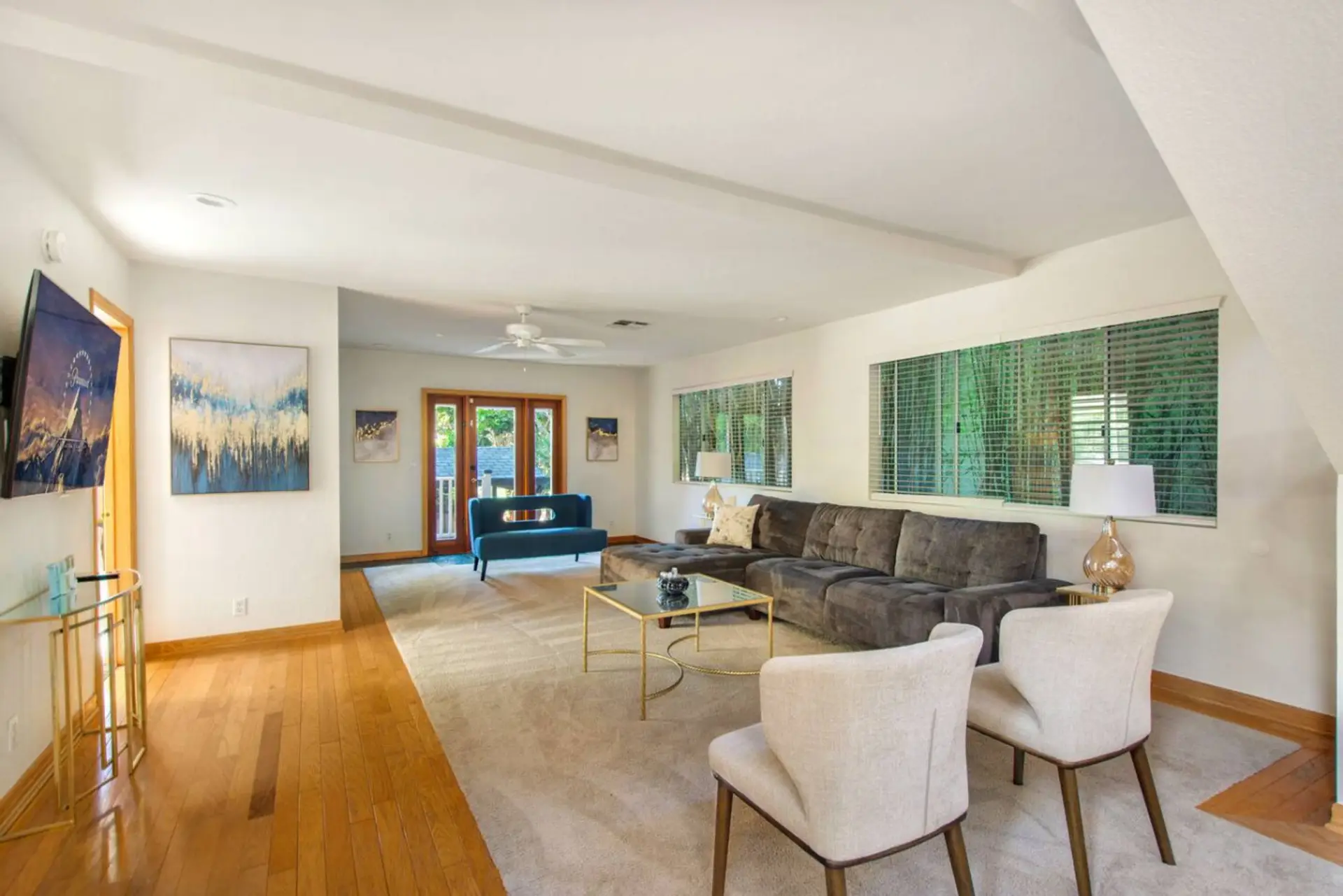Bright and spacious living room with cozy seating and doors that open to the patio