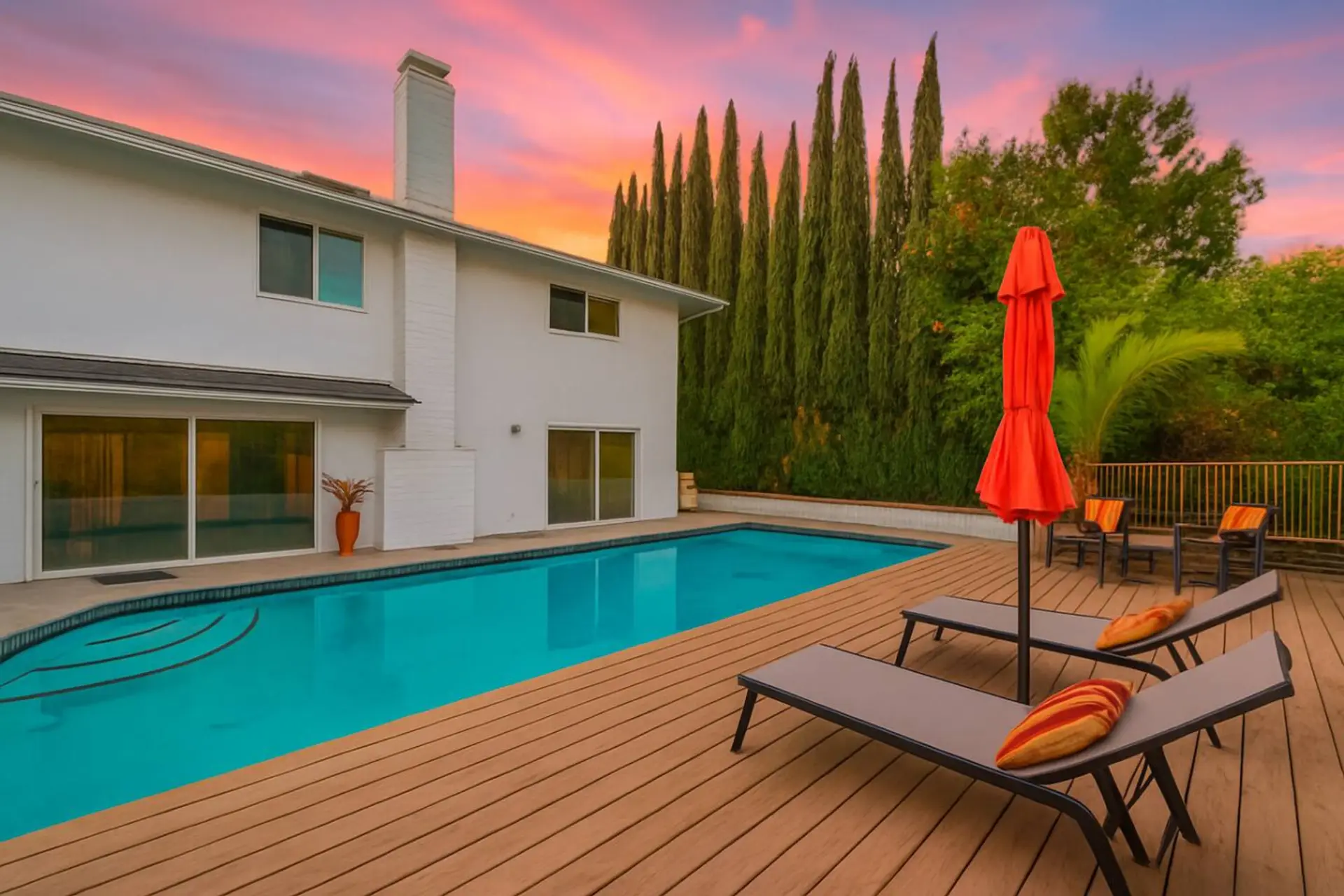 Private backyard oasis with sparkling pool, sun loungers, and plenty of space to relax or entertain.