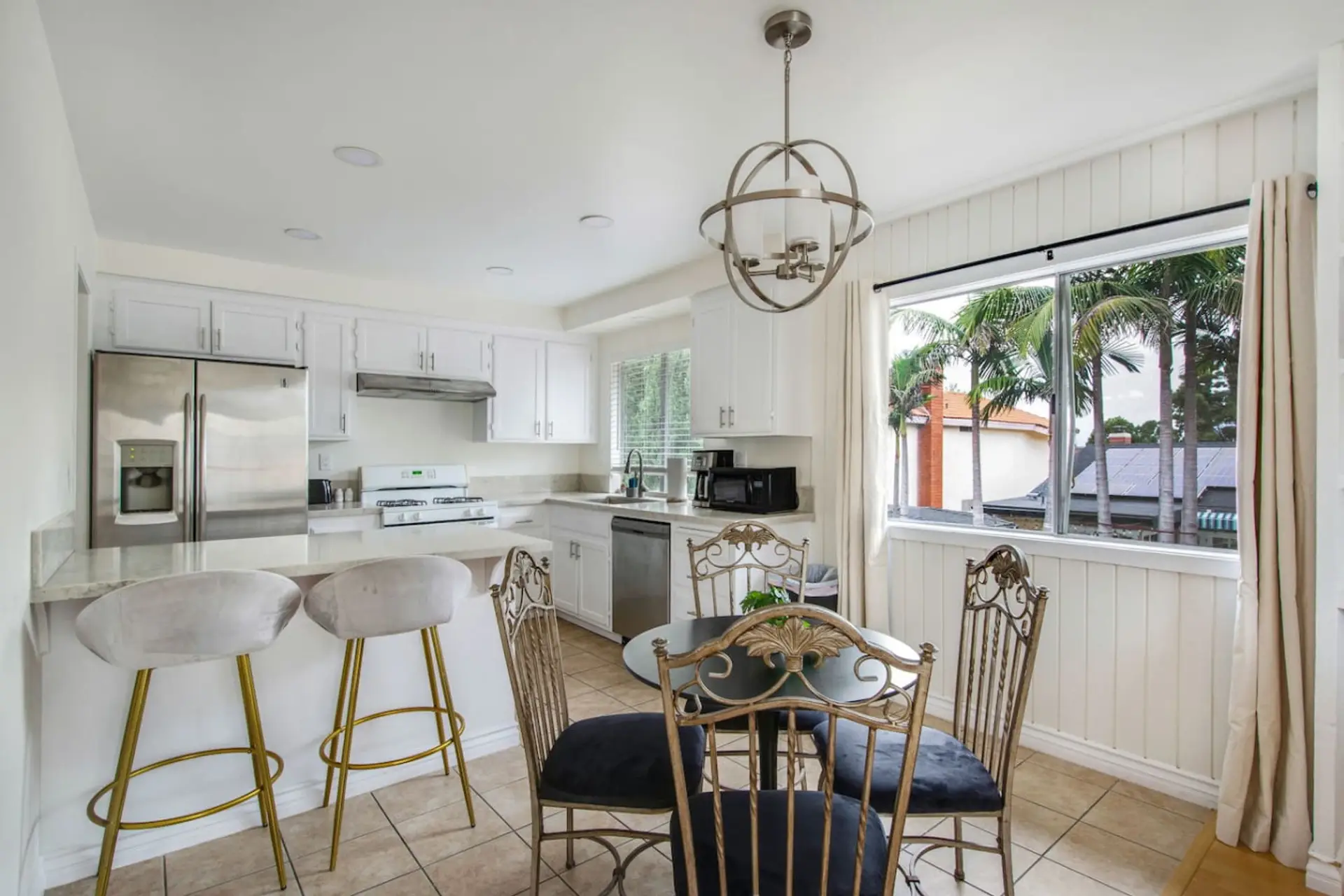 Fully equipped kitchen with breakfast bar and dining area, perfect for meals at home