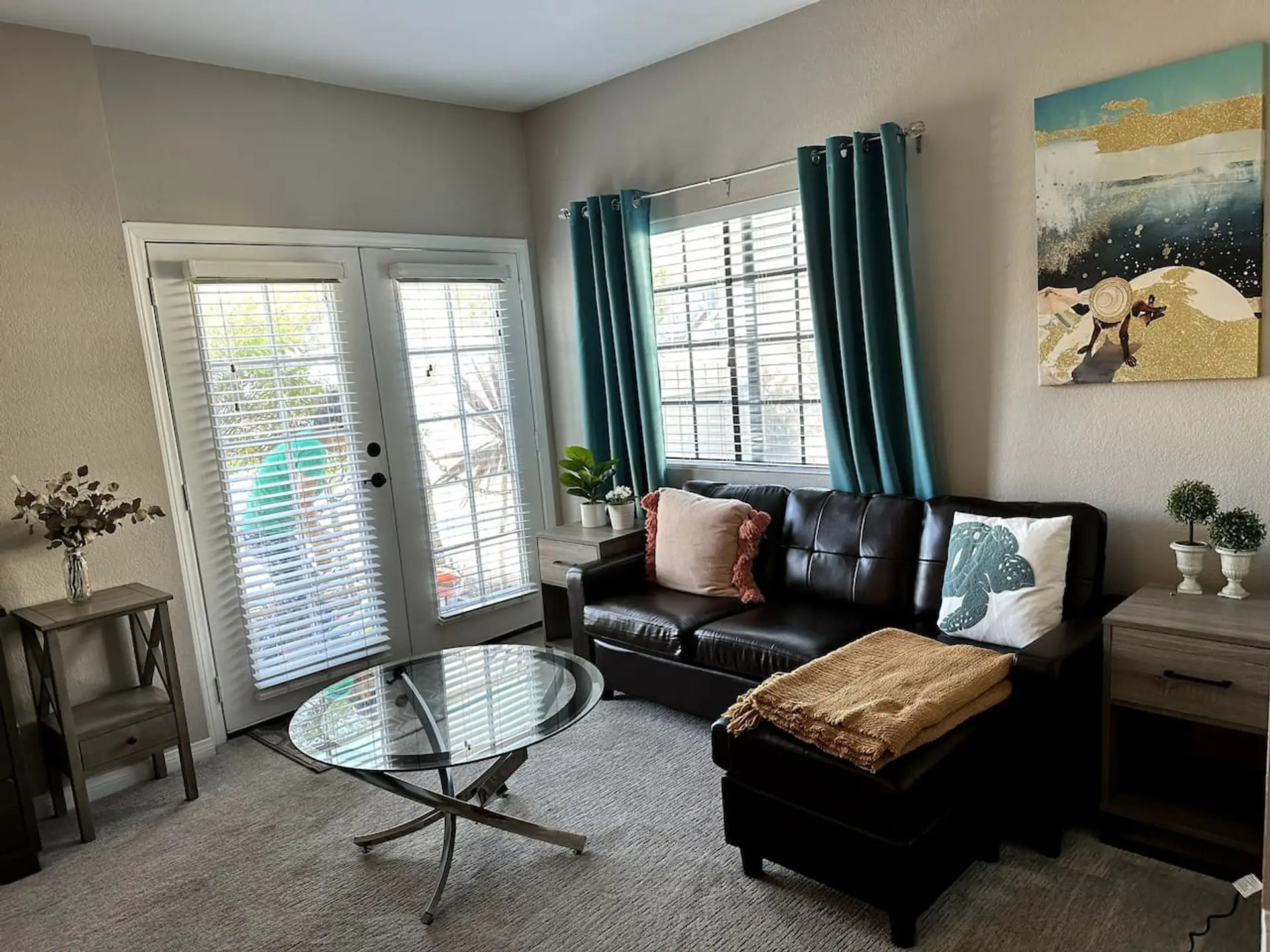 Bright and comfortable living room featuring a Smart TV (log in to your favorite streaming apps) and a cozy couch,