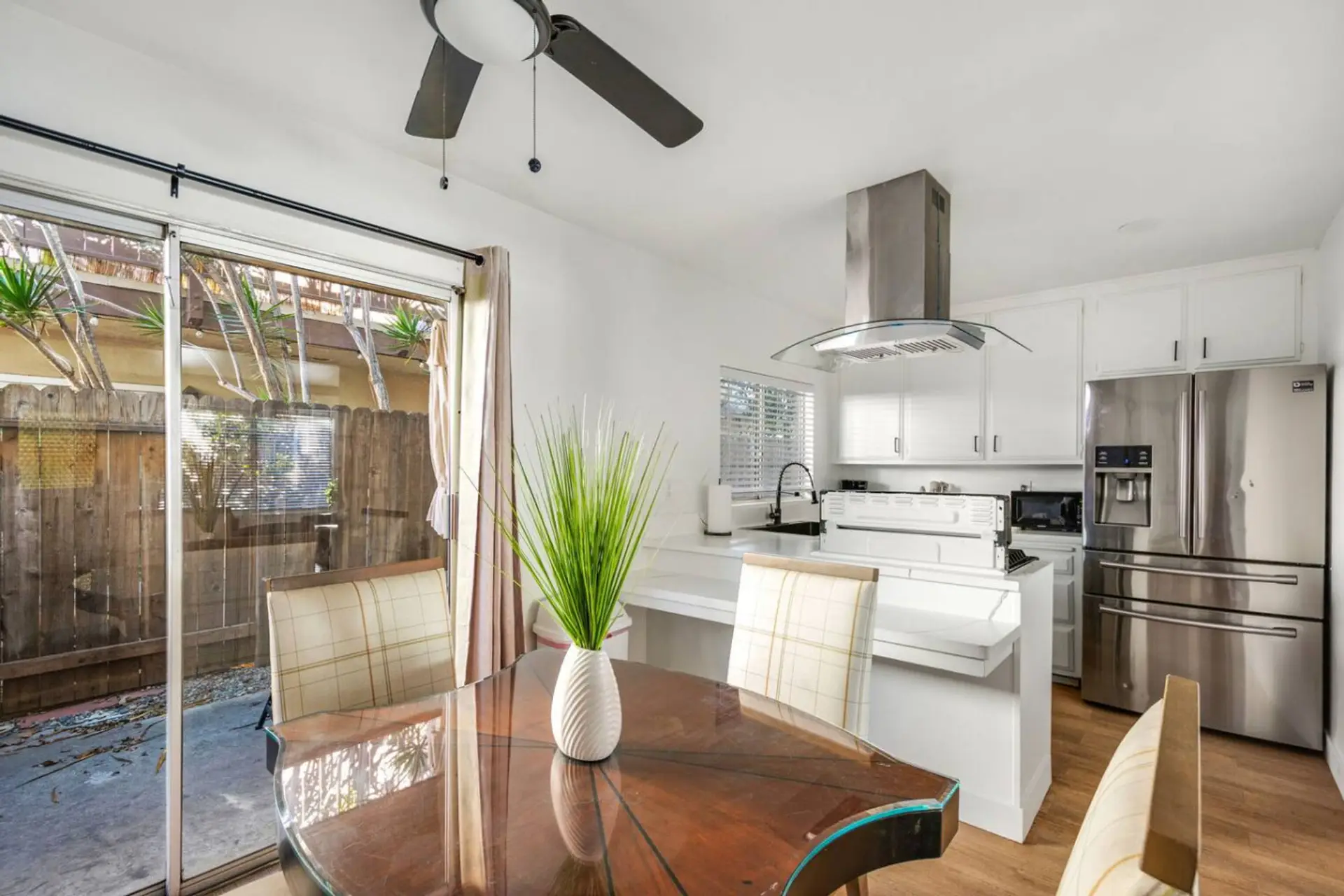 Open dining area with seating for five, connected to a fully stocked kitchen