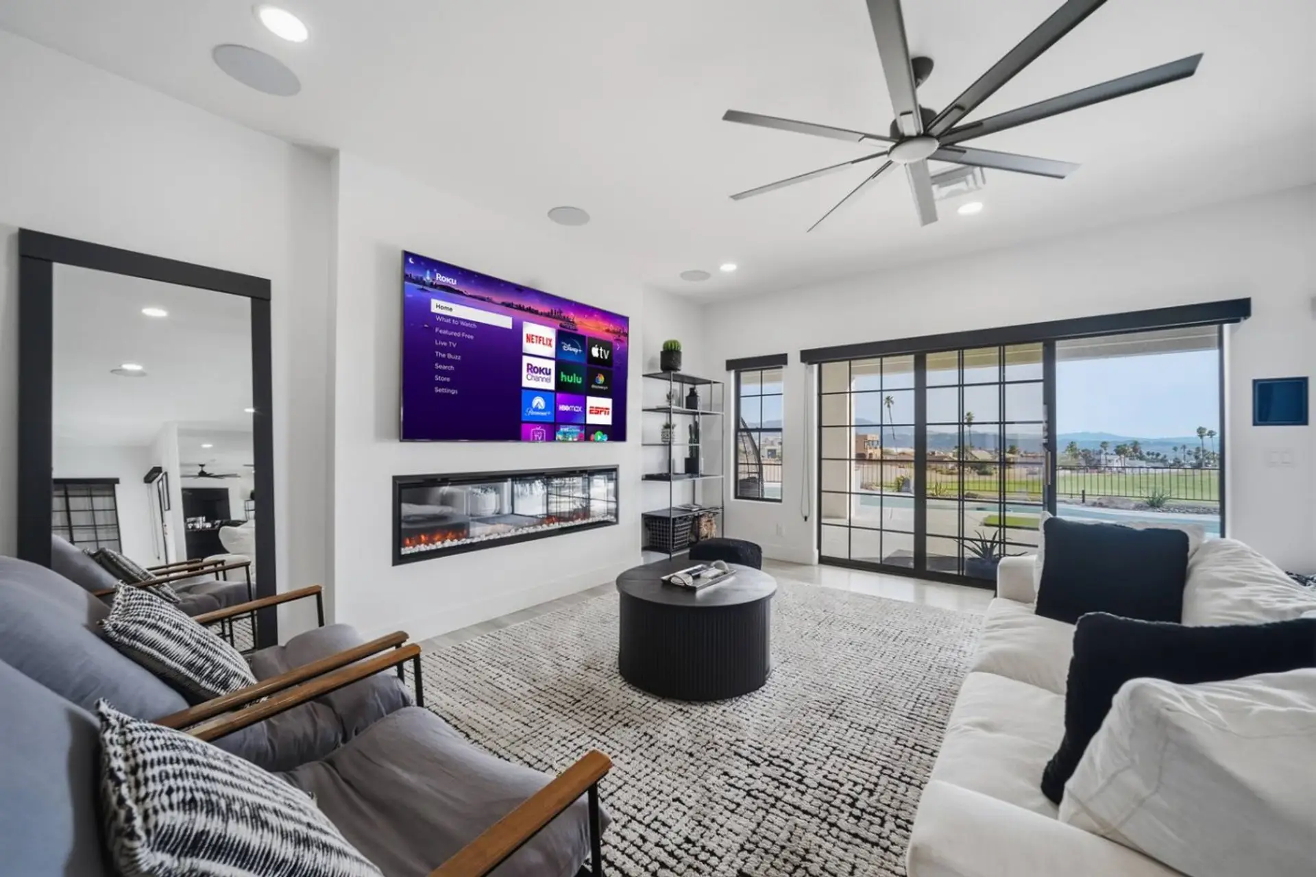 Open-concept living area with a Smart TV and modern fireplace.
