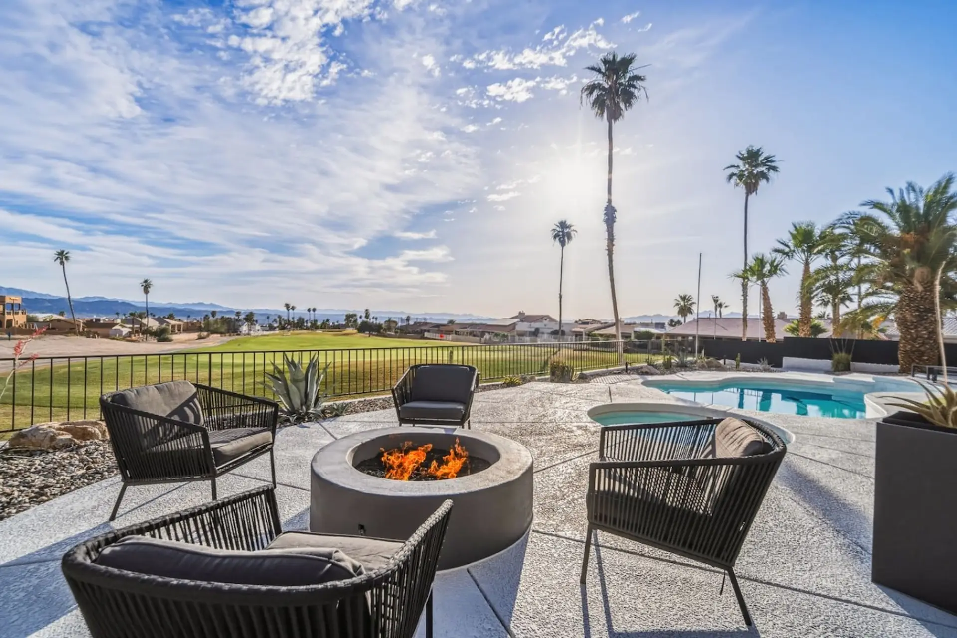 Cozy firepit seating with views of the 13th hole.