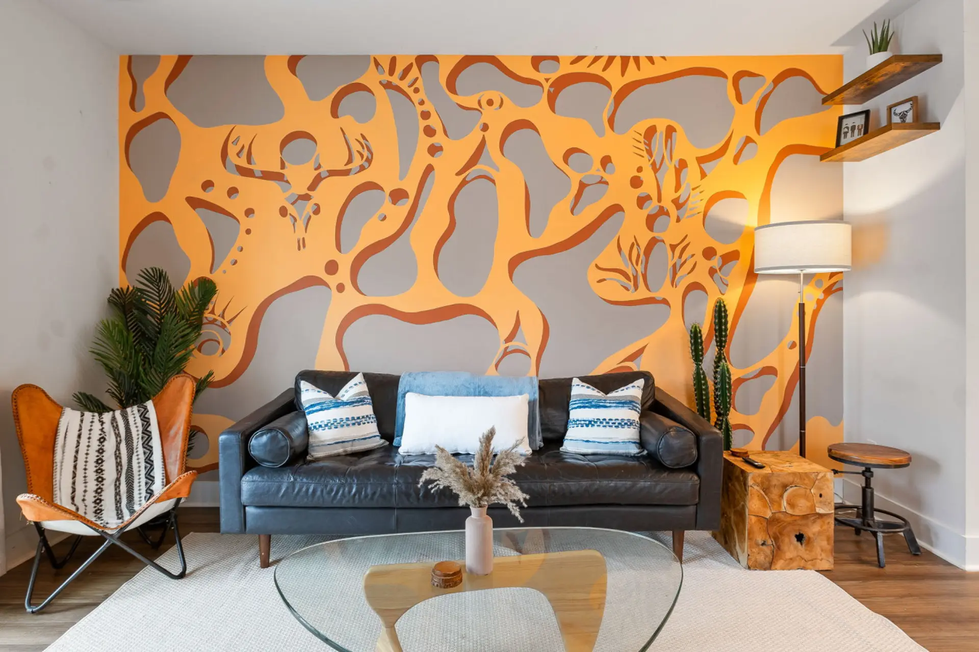 That statement-making mural isn't just wall art - it's a conversation starter that makes this living room unlike any other rental in Charleston