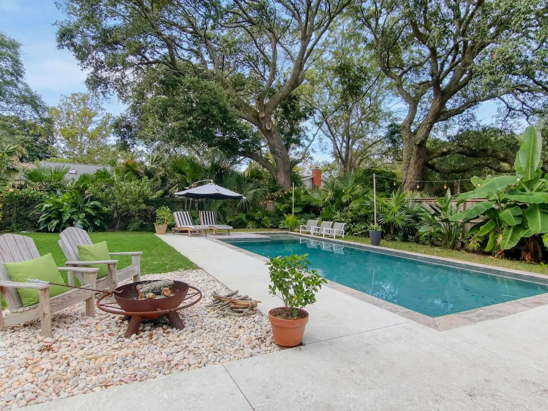 Your own private oasis under ancient live oaks - lounge by the pool, gather around the firepit, or claim one of those Adirondack chairs with your morning coffee