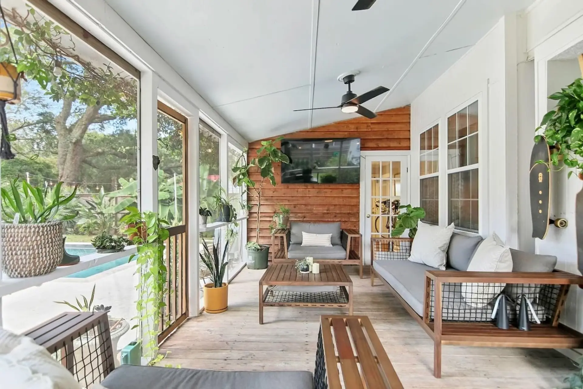 Your own screened-in sanctuary with lounging for everyone, plants that actually thrive, and an outdoor TV for those lazy poolside afternoons