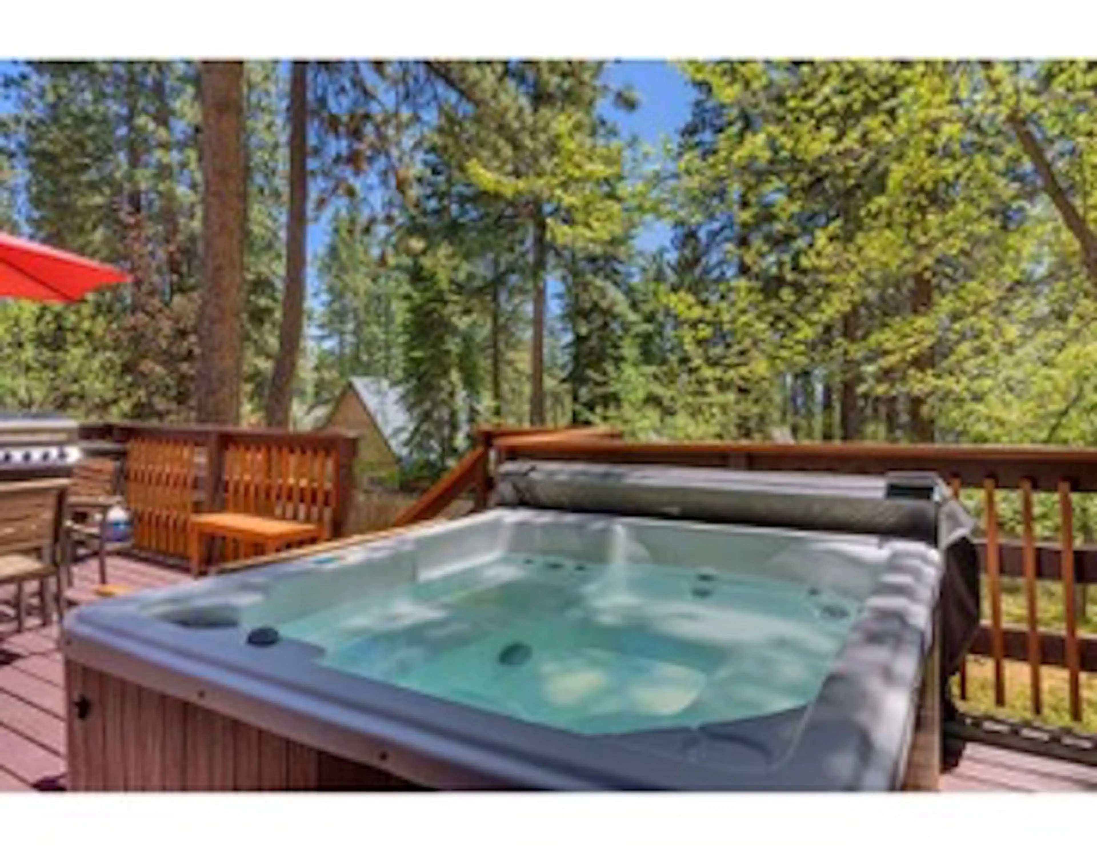 Private hot-tub on back deck overlooking large backyaard.