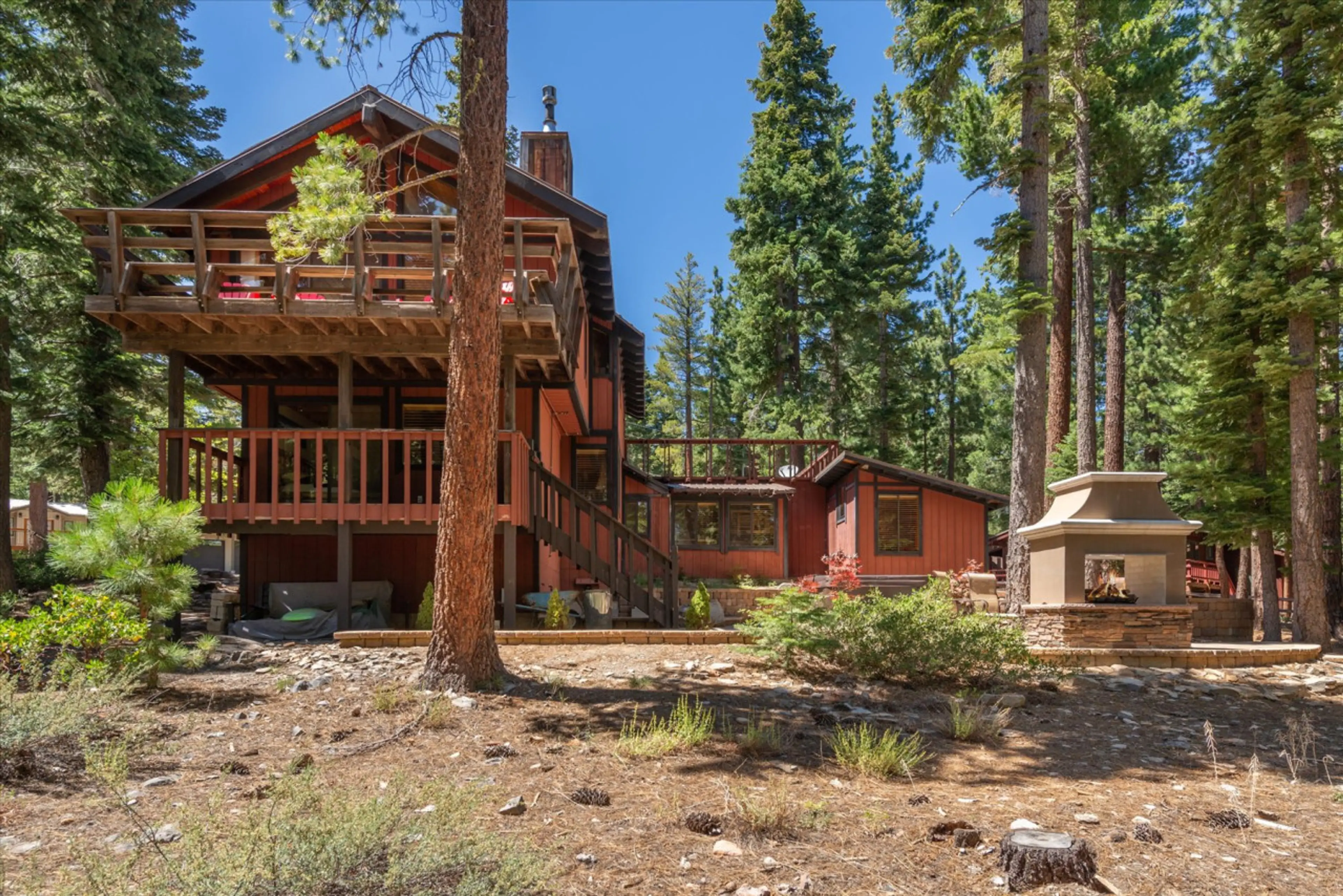 Back of house with multiple decks, hot-tub, fireplace, and more all with amazing views.