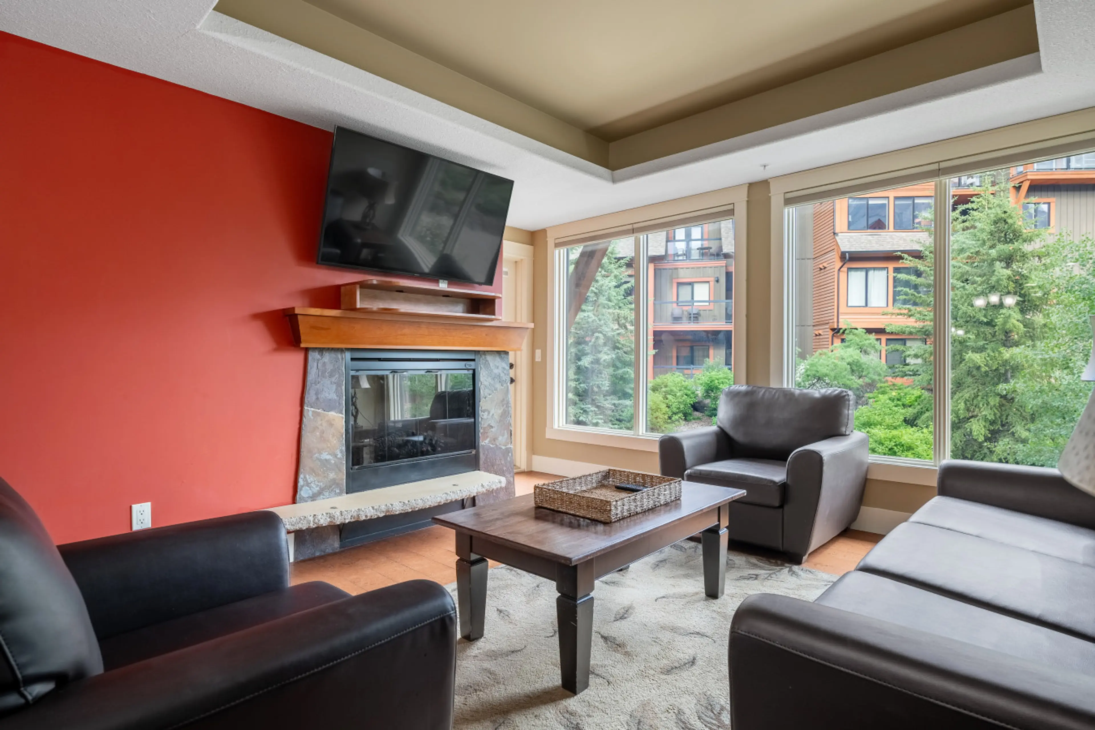 Experience fireside serenity, gazing at nature through grand windows.