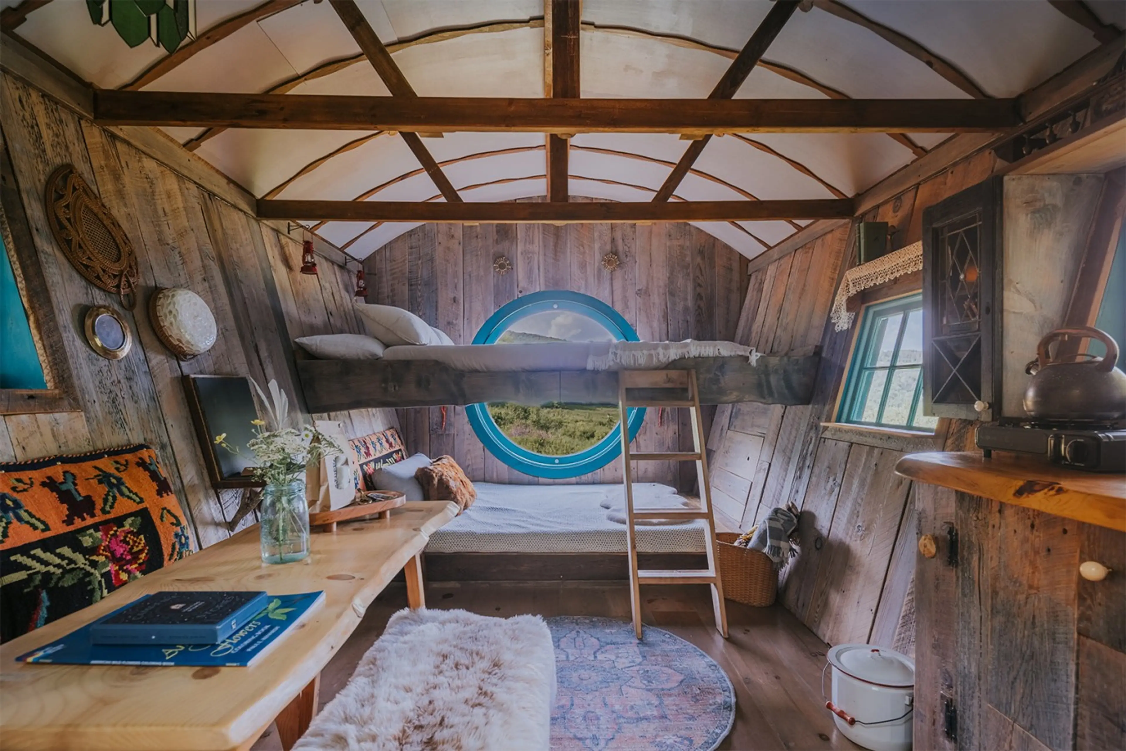 A handcrafted off-grid cabin with two queen beds, a custom round picture window, and mountain views. Sleeps up to four guests.